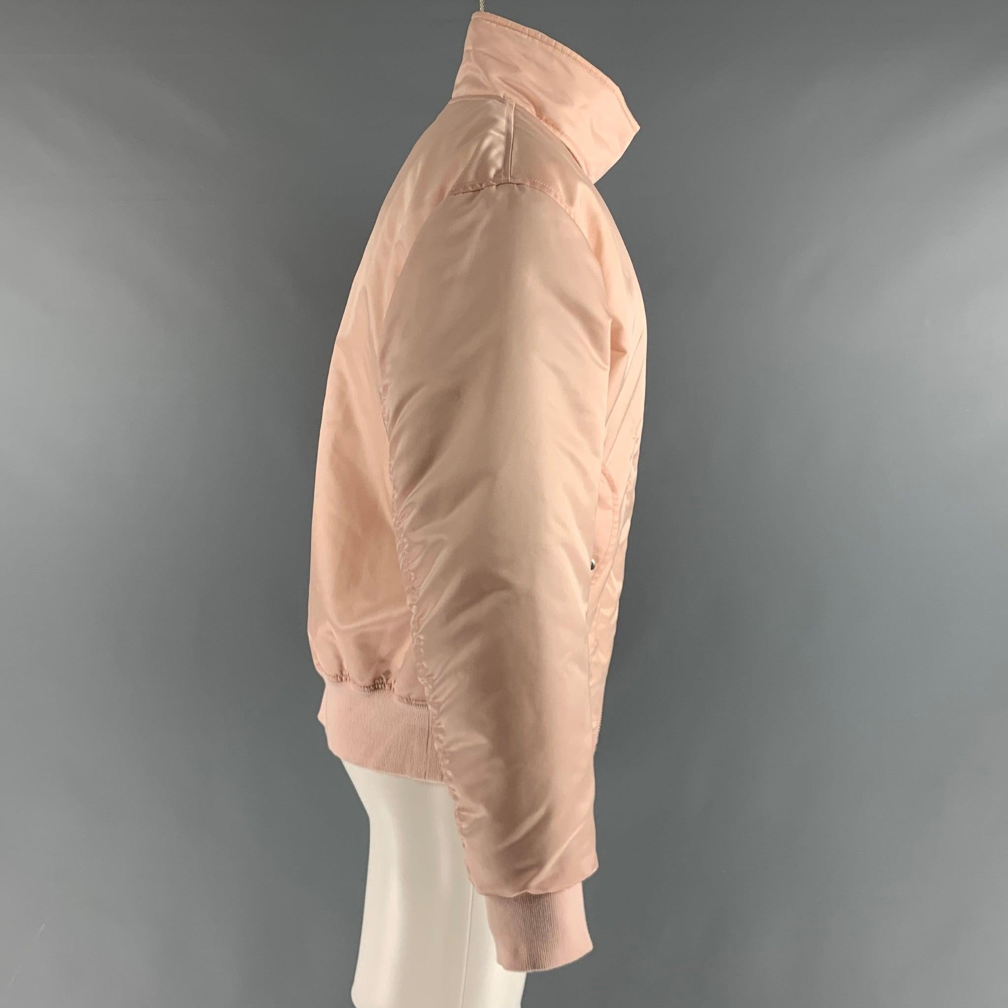 HELMUT LANG jacket comes in a pink nylon woven material featuring a bomber style, ribbed hem, flap pockets, buttoned collar, and a full zip up closure. Very Good Pre-Owned Condition. Minor marks. 

Marked:   M 

Measurements: 
 
Shoulder: 21.5