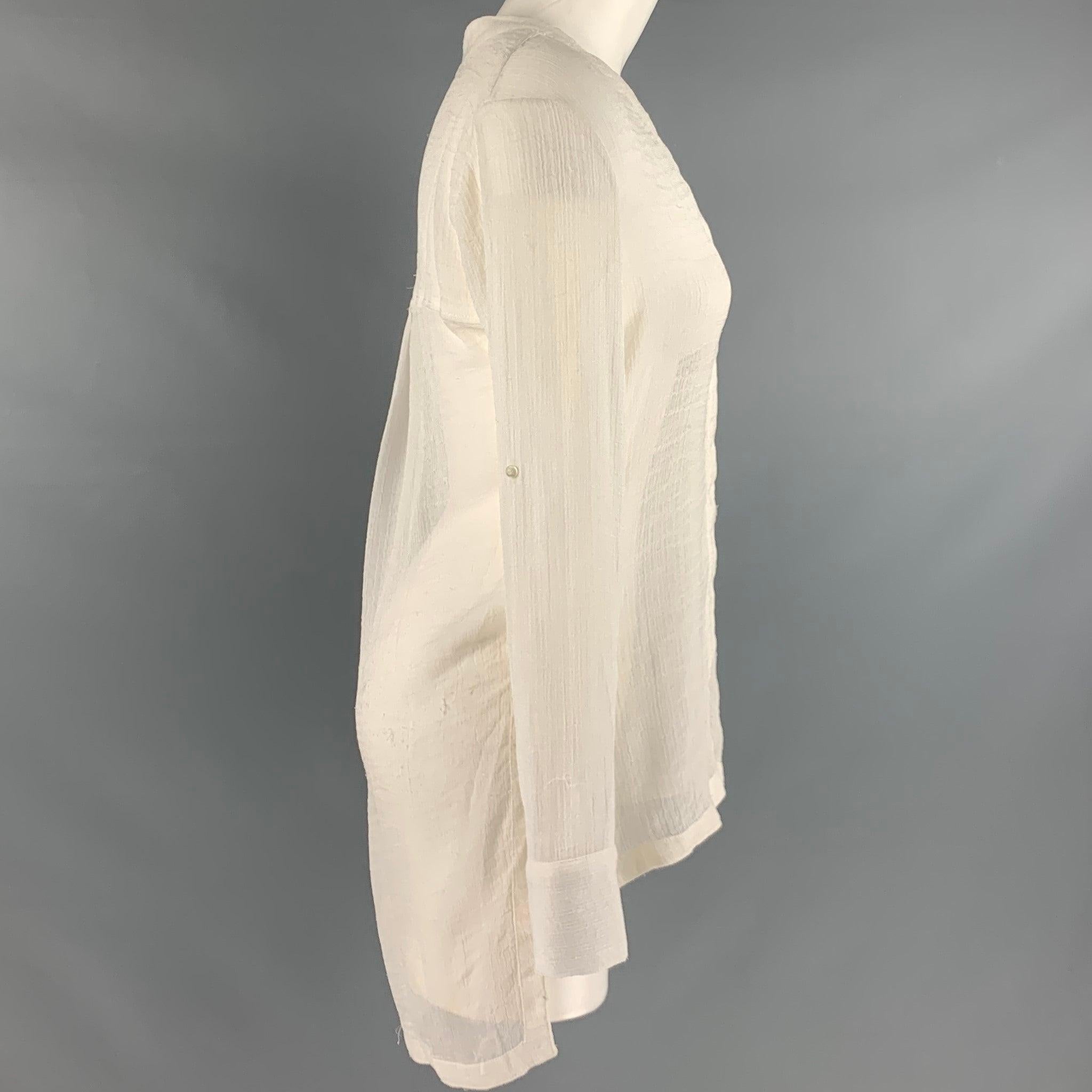 HELMUT LANG casual top
in a white triacetateblend fabric featuring a sheer see through hi-low style, long sleeves which can be rolled up, a V neck, and a hidden button closure. Made in USA.Very Good Pre-Owned Condition. Minor mark on front. As-is.