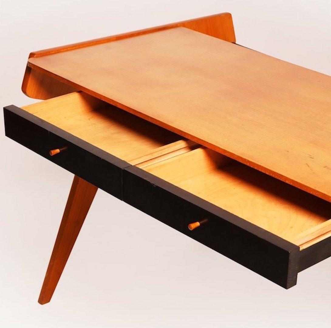 This unique Helmut Magg for WK Möbel Desk features vibrant elm wood which contrasts beautifully with the black veneer drawers and bookshelf. WK Möbel was known for their impeccable craftsmanship.