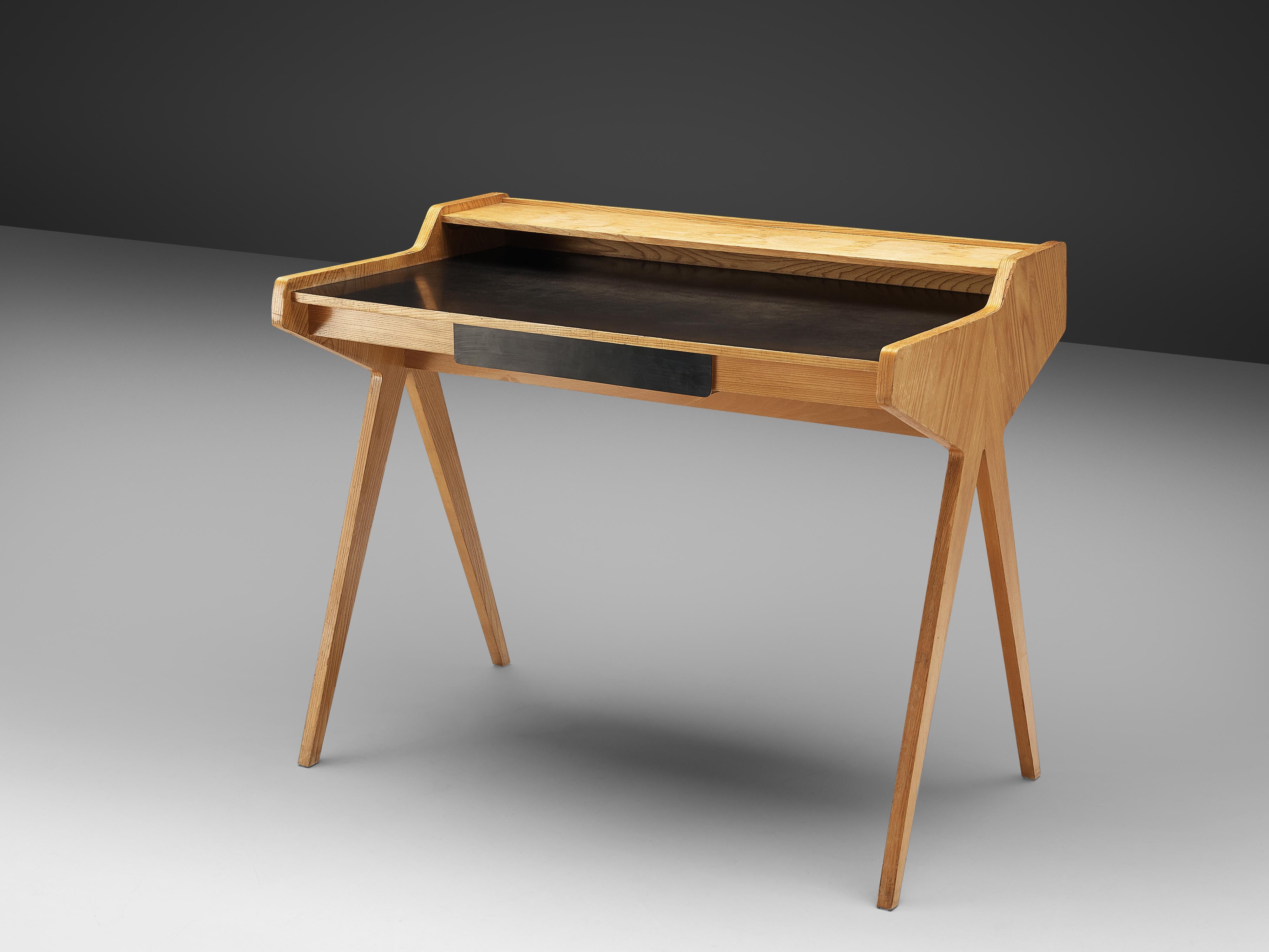Helmut Magg for WK Möbel, veneerd cherrywood, Germany, 1950s

This ‘lady desk’ by German architect and furniture designer Helmut Magg (1927-2013) breathes the aesthetics of 1950s design. Two V-shaped, tapered legs lift up the table. The top is
