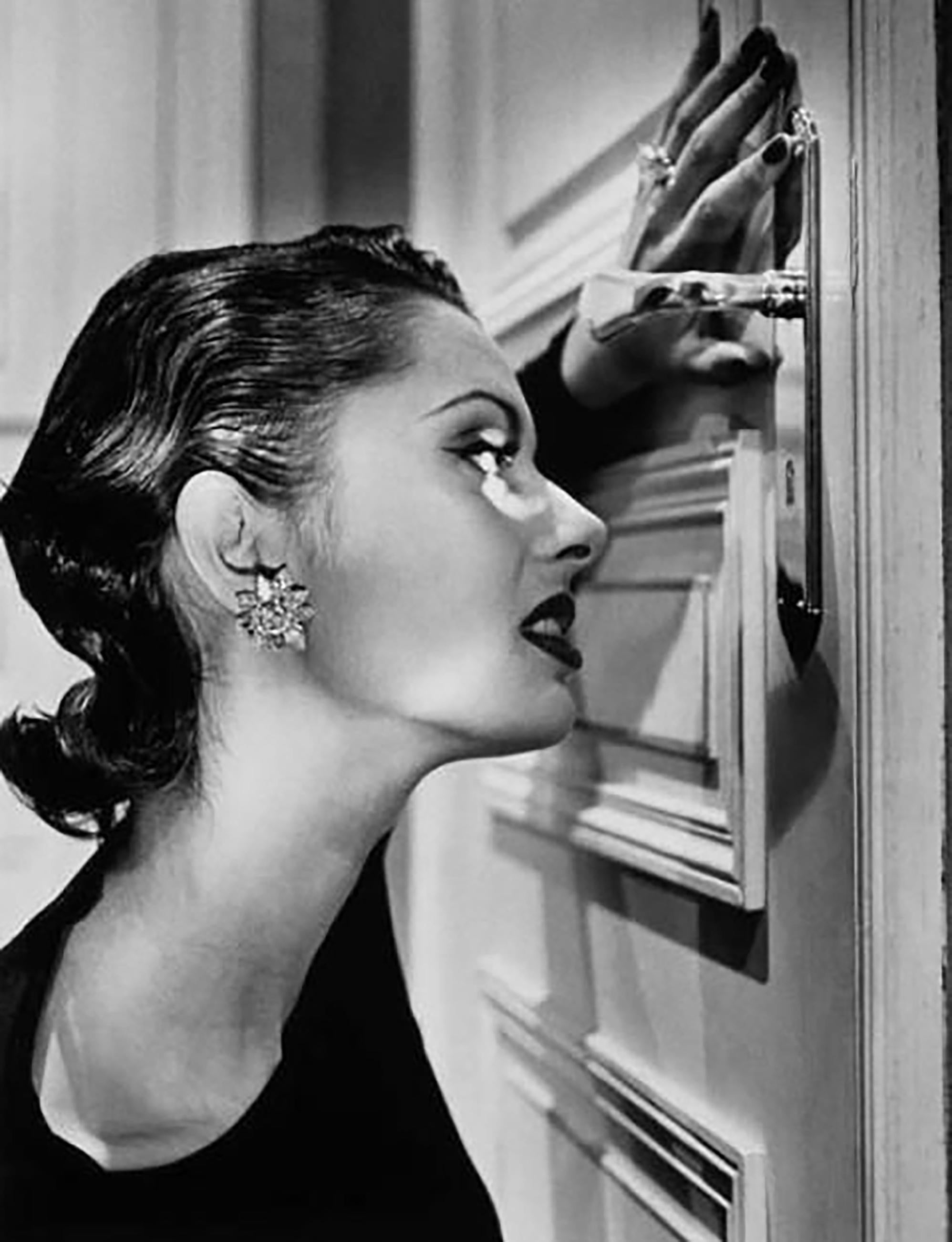 Helmut Newton Black and White Photograph - Heather Looking Through a Keyhole, 1994