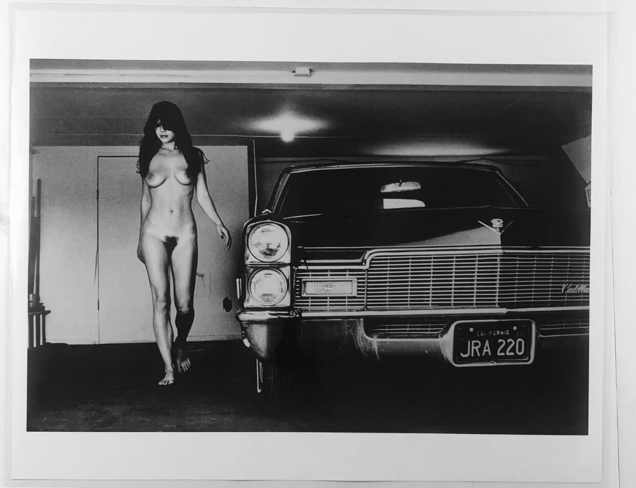 In ‘Hollywood 1976 Cadillac in Garage’, Newton plays on the idea of parking multiple cars in your garage. Channelling the twin boyhood desires of girls and cars, there is a sense of seduction and danger to both as they come towards you. Newton was