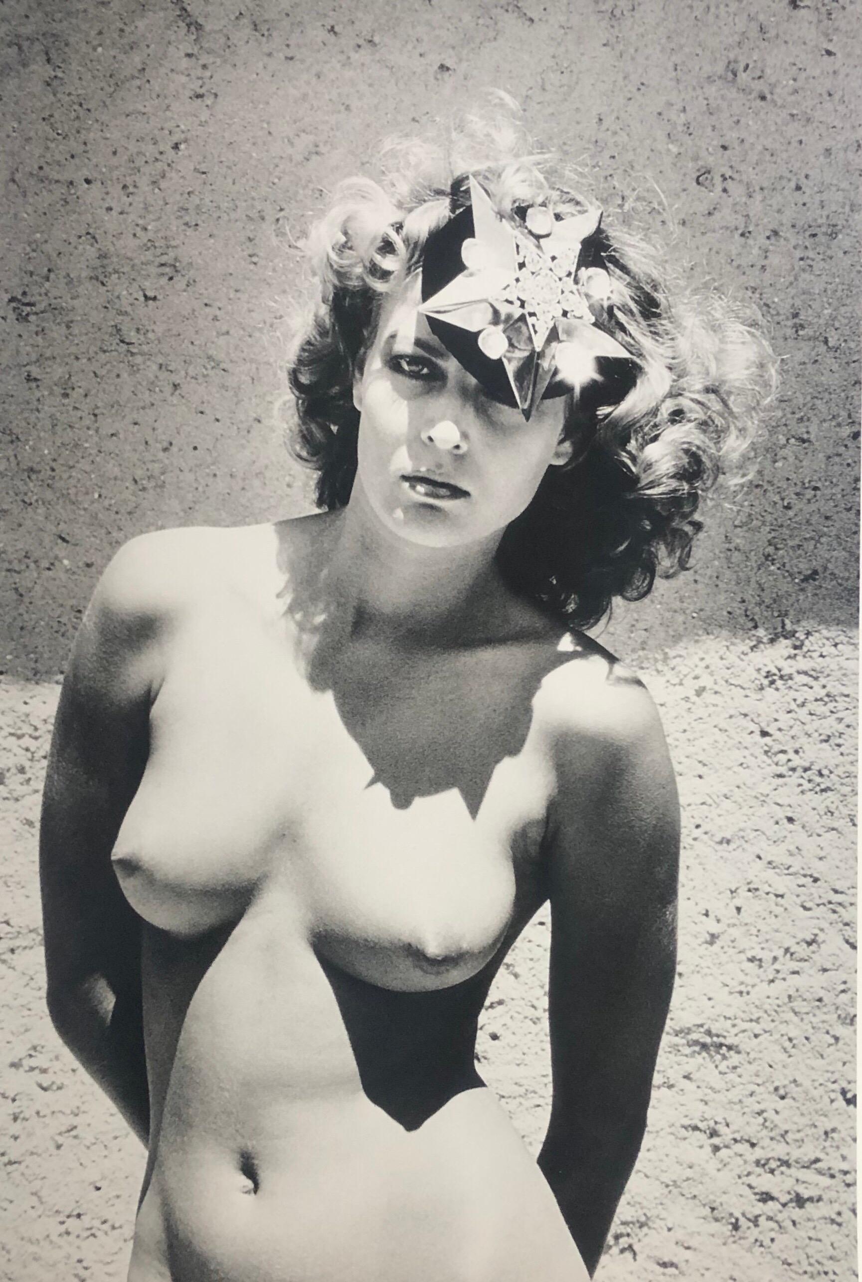 Original early 1980's vintage original silver gelatin print of one of the rarer images in the collection simply titled "Model in Hat'.  Image depicts a playful model in nothing but an elegant hat believed to be shot by Newton in the late 1960' in