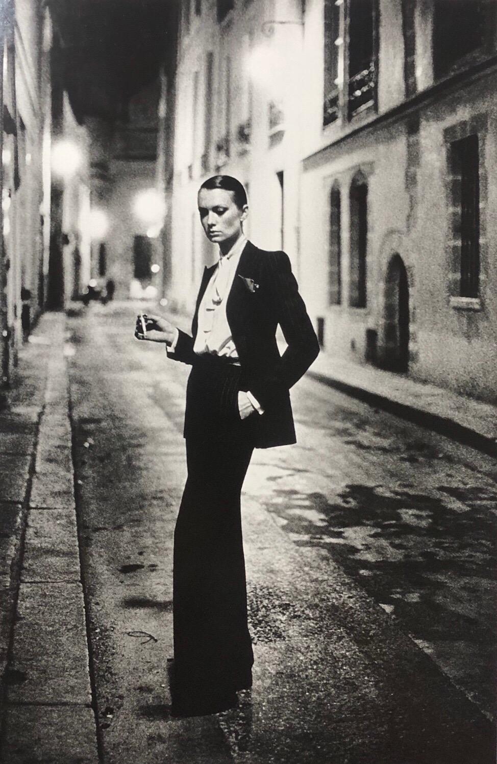 Original early 1980's silver gelatin print title "Rue Aubriot" featuring actress Vibeke Knudsen alone in a lamp lit Parisian street. The image has become one of Helmut Newton's most popular and widely collected.  Styled in a deliberately androgynous
