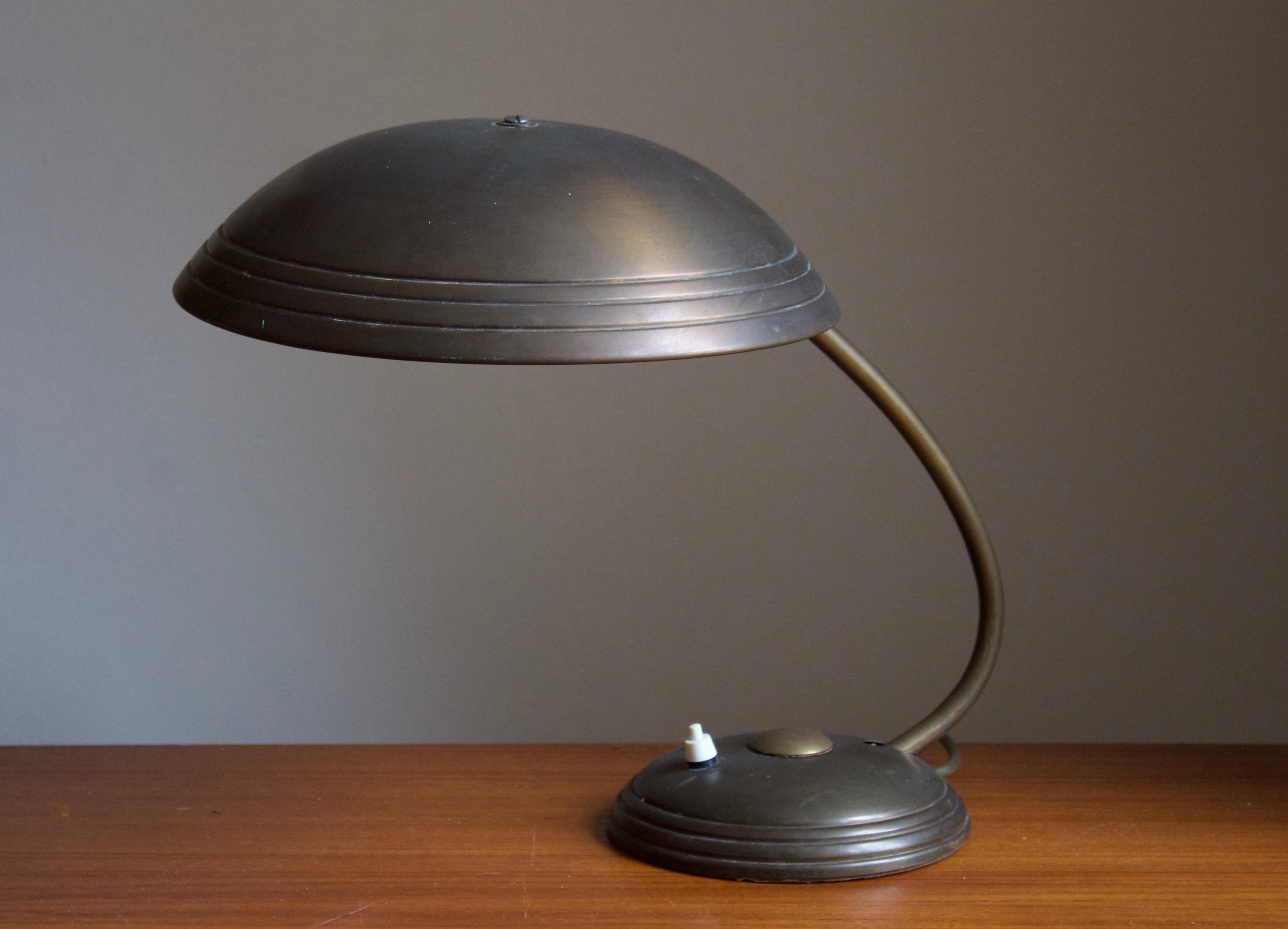 An adjustable table lamp / desk light. Designed and produced by Helo, Germany, 1950s.

  