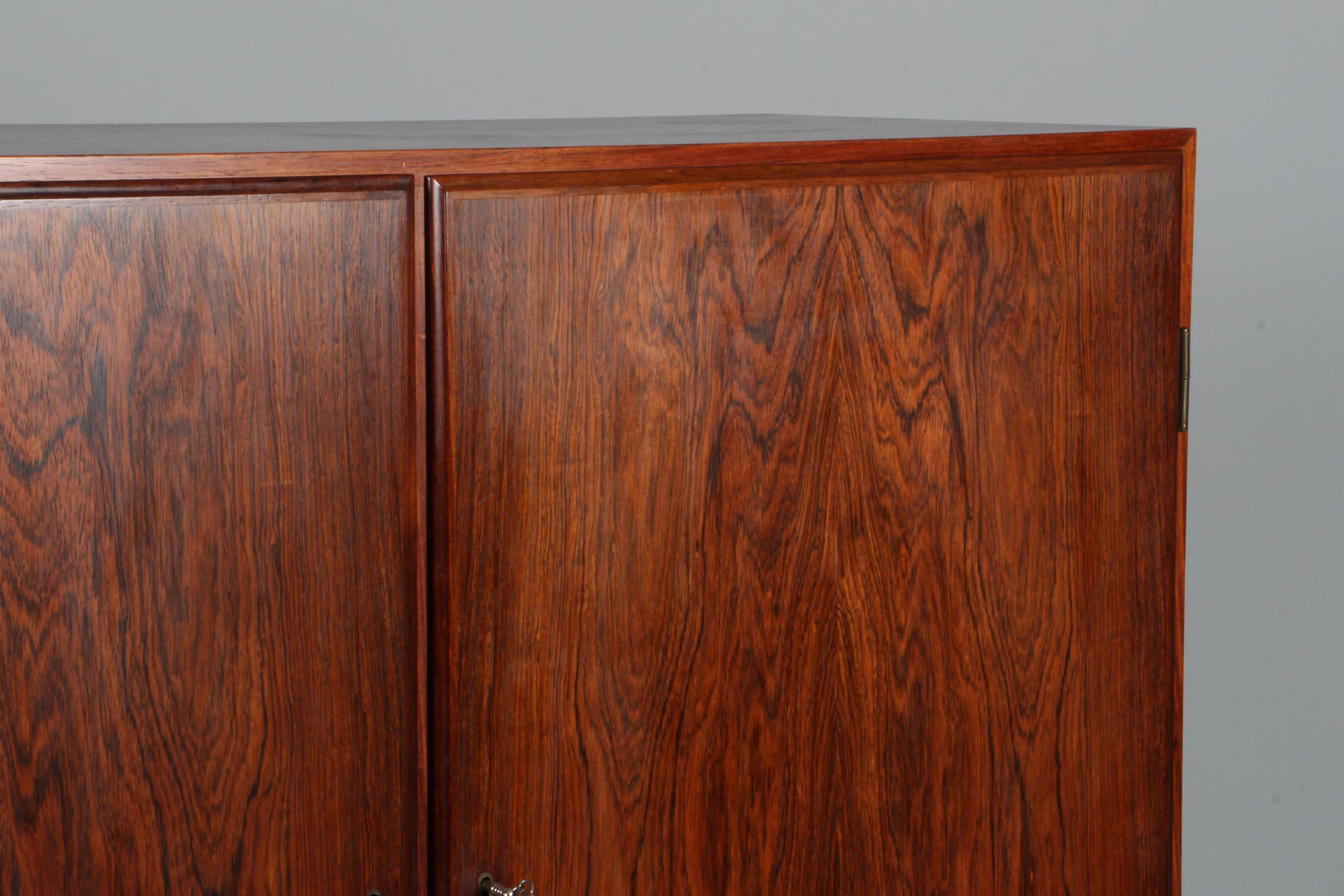 Heltborg cabinet of rosewood with drawers and doors.

Made by Heltborg Møbler.