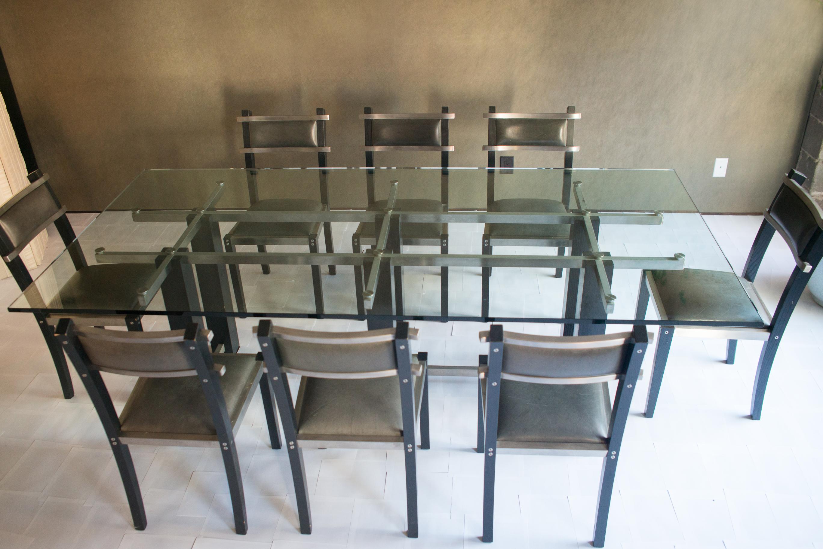 Sleek and shapely industrial style dining set. Solid maple frames and brushed stainless steel back slats give this set a sophisticated finish and attention to detail.f. Seats upholstered in Edelman leather.

Heltzer was founded in 1986 as a way to
