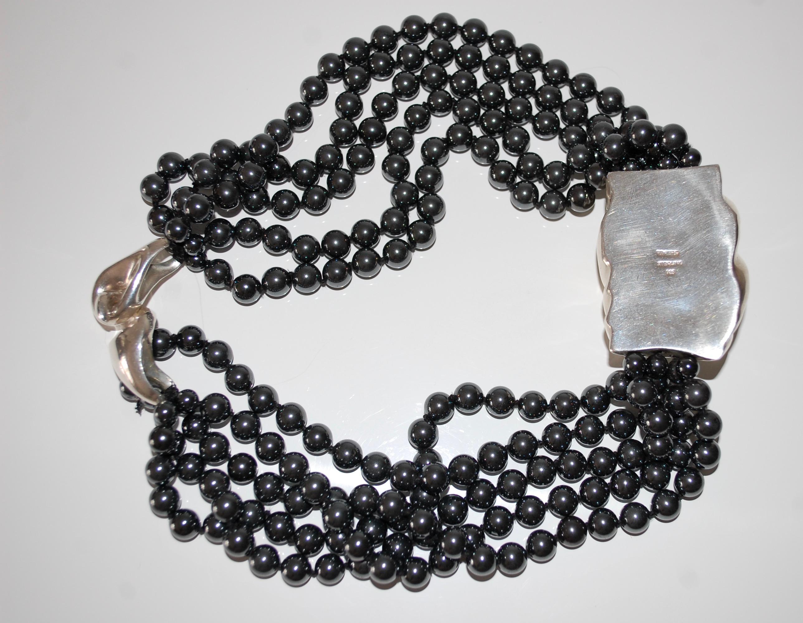 Patricia von Musulin
Hematite and sterling silver torsade necklace.
Designed with five strands of graduated round hematite beads size about 7 mm and elegant sculpted sterling silver pendant in the center.  
Signed von Musulin
about 19.5