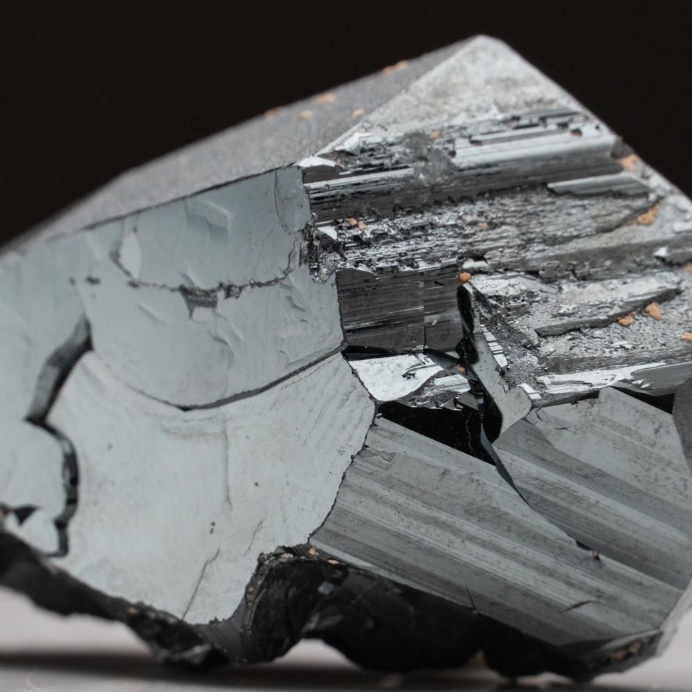 From Wessels Mine, Kalahari Manganese Field, Northern Cape Province, South AfricaLarge crystals of dark-metallic hematite with mirror-like luster on most crystal faces and fine striations on other faces. The side and rear have naturally crystallized
