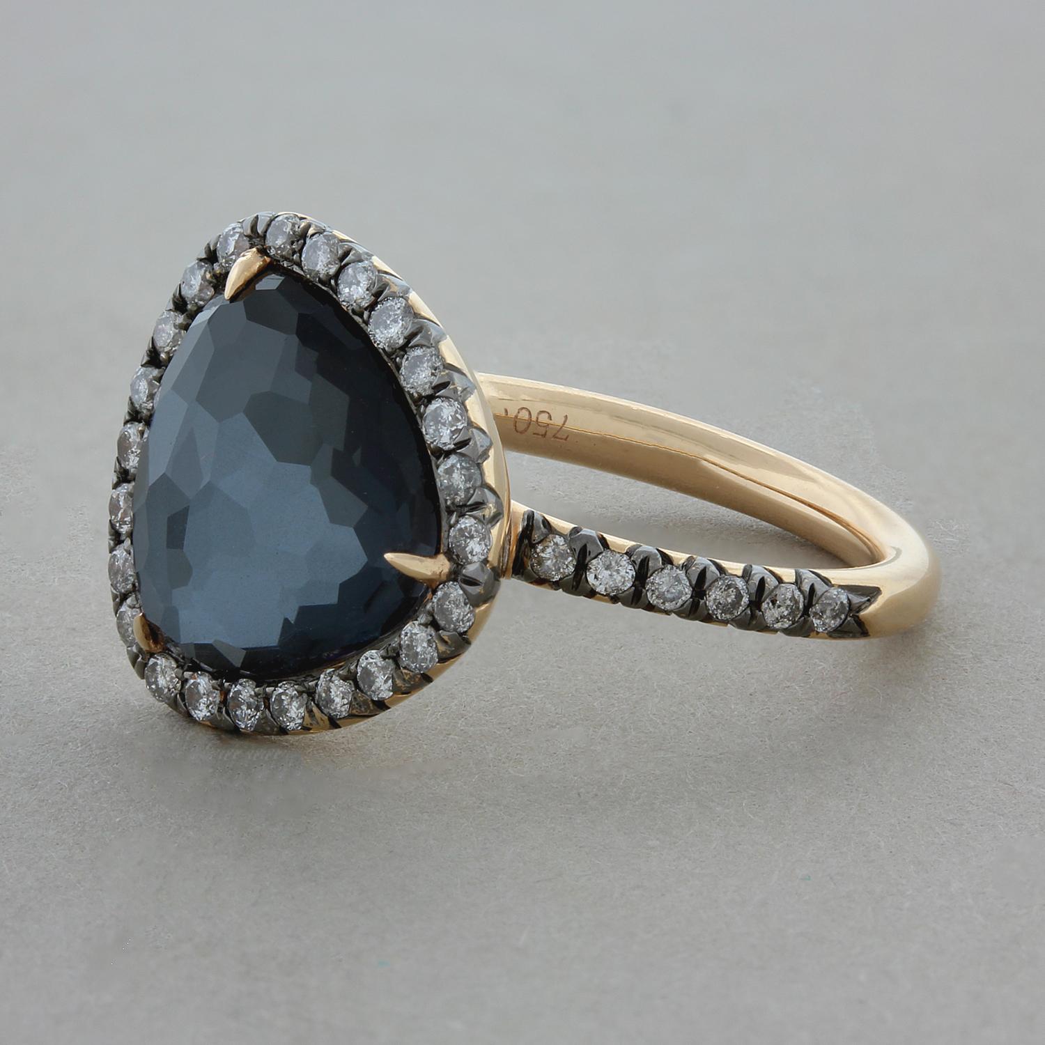 This unique everyday ring features a 2.80 carat trillion cut colorless quartz that is set directly on-top a piece of hematite giving the quartz a rich metallic color. It is accented by 0.49 carats or round brilliant cut diamonds that create a halo