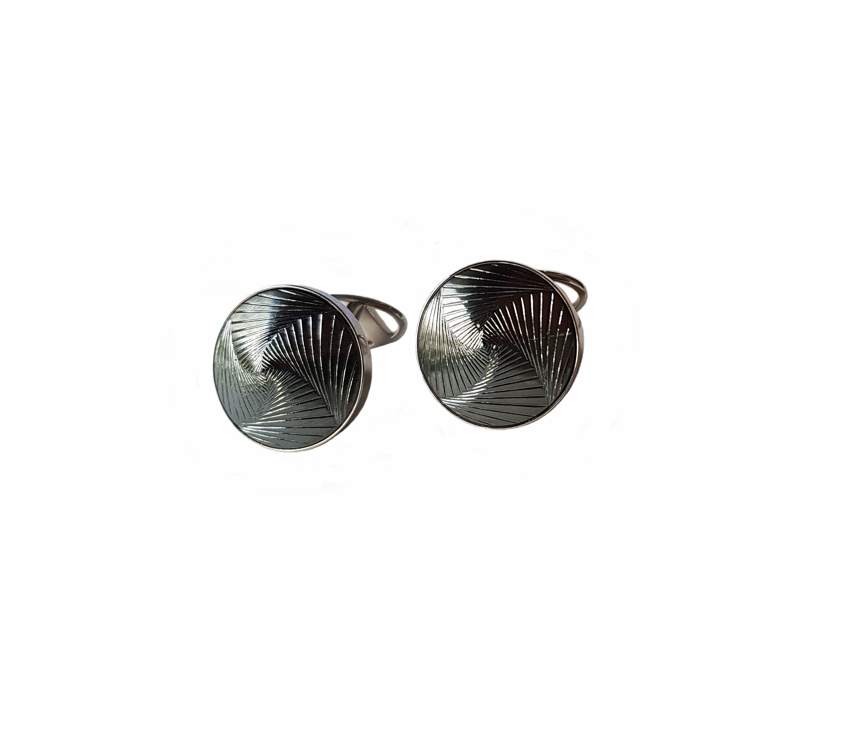 Stunning cuff-links by Wagner Preziosen made of 750/0 White Gold and hematite engraved with a mesmerizing spiral structure. A completely new cut from a very artistic Stone cutter (Carlo Wild) from Idar Oberstein.  Very elegant and modern design and