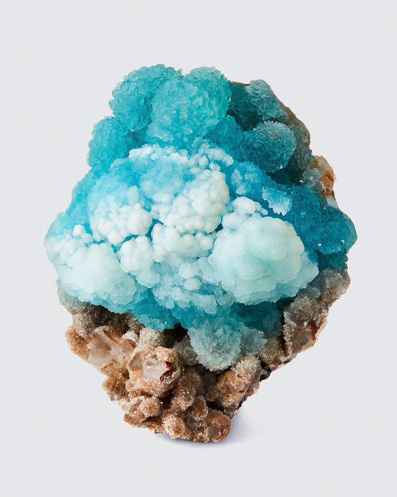 Hemimorphite on Quartz, Malipo Mine, Wenshan Co., Yunnan Prov., China
Measures: 12 cm tall x 10 cm wide

Hemimorphite from China has taken on entirely new qualities that barely existed anywhere else on Earth. The intensity of color and the
