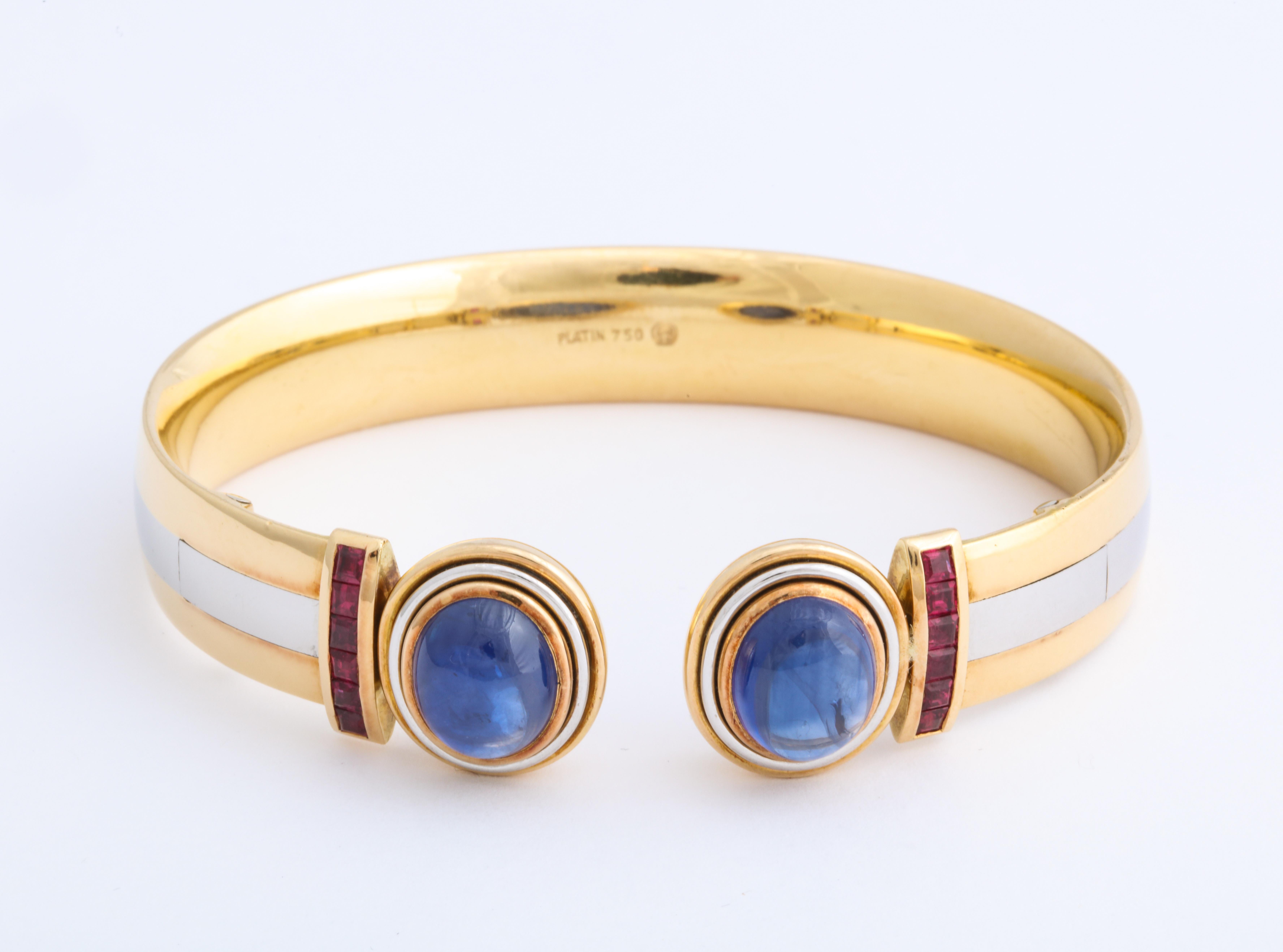 World-renowned Munich-based designer Stefan Hemmerle created this artful hinged bangle bracelet contrasting colors, shapes and textures for a modern statement in cabochon sapphire (2 = 12cts) accented by square-cut rubies in a platinum and 18KYG