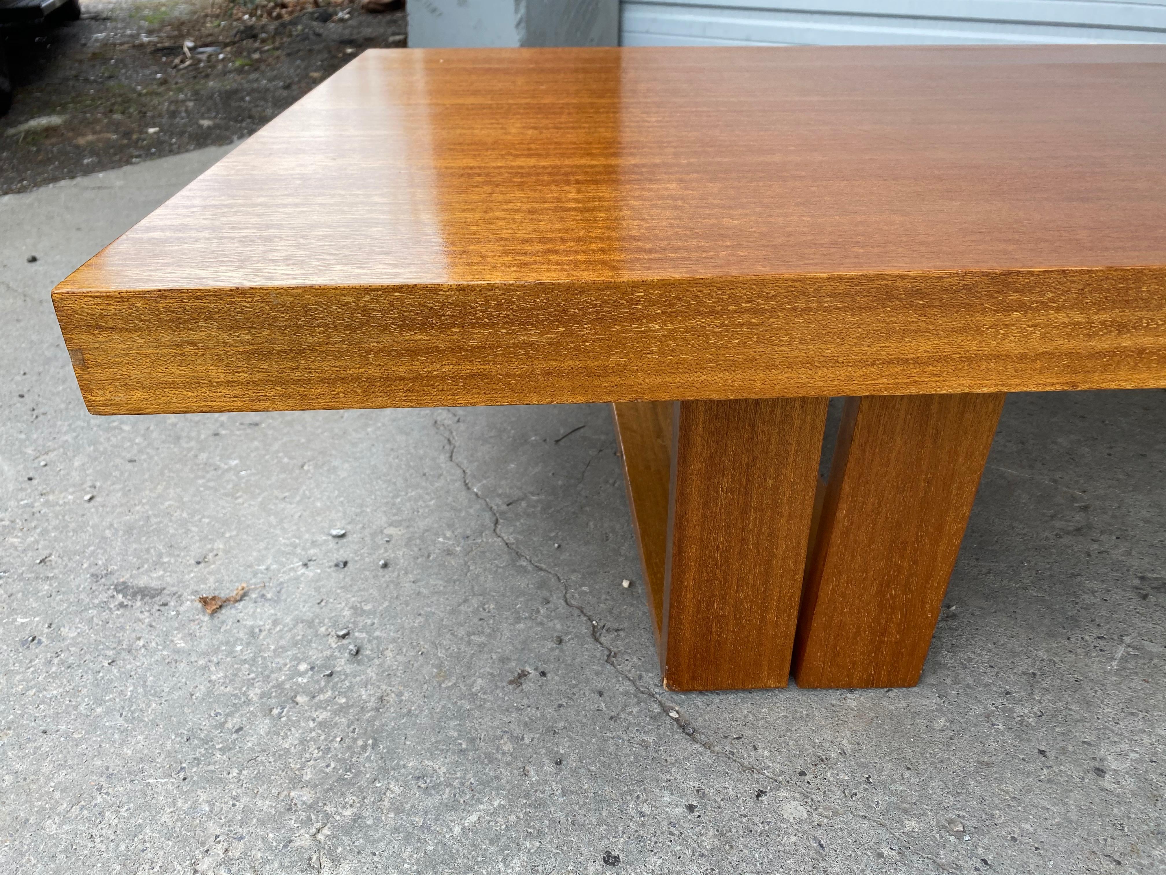 This beautiful and highly functional table designed by Hendrik Van Keppel and Taylor Green can convert from a coffee table to a dining table, work table or desk. Stunning ribbon mahogany. The ingenious design features legs which are hinged to fold