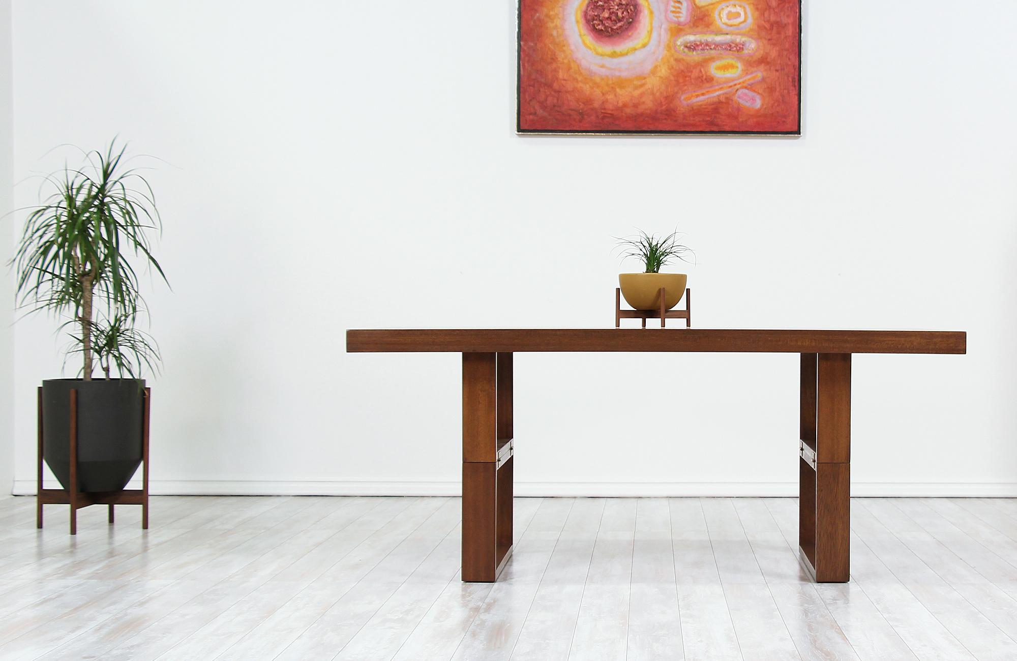 Unique table designed by Van Keppel Green and manufactured by Brown Saltman in California circa 1950s. This ingenious design features a walnut-stained mahogany frame that is supported by a linear, geometric base. Known as the Camel table due to its