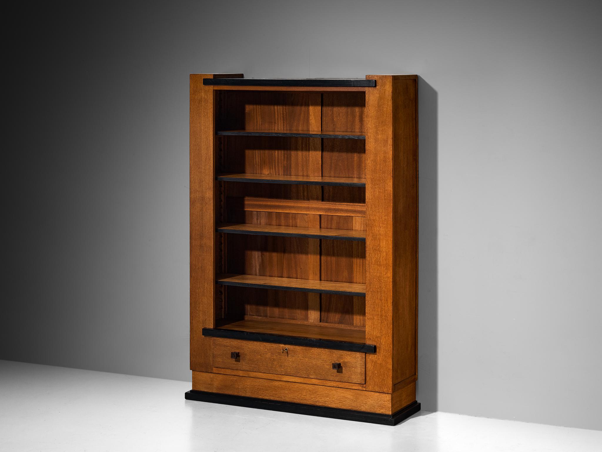 Hendrik Wouda for Pander & Zonen, bookshelf, oak, coromandel, brass, the Netherlands, circa 1925

This impeccably balanced bookshelf features a sleek rectangular form, defined by strong vertical and horizontal lines, offering ample storage space.