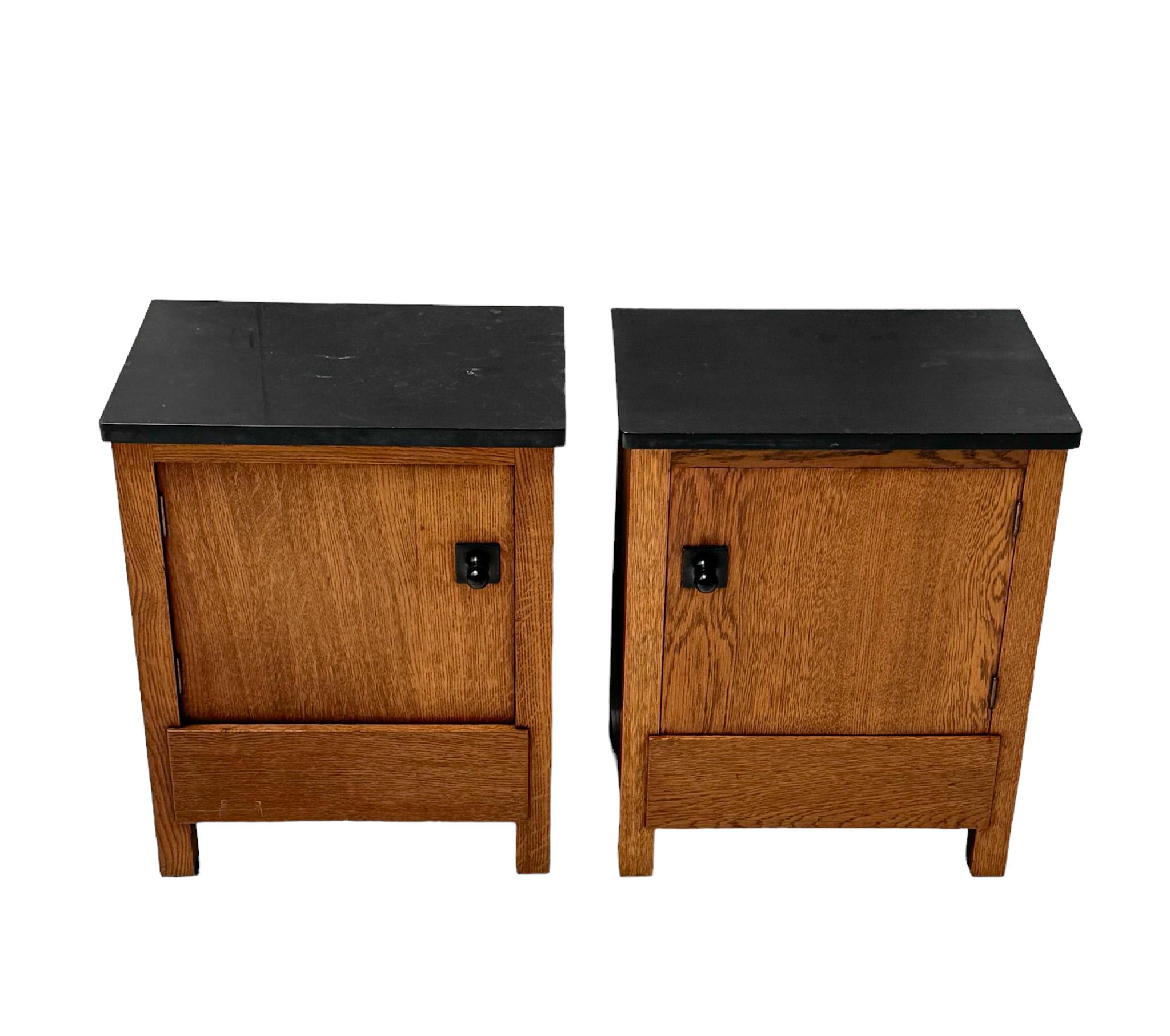 Magnificent and rare pair of Art Deco Modernist nightstands or bedside tables.
Design by Hendrik Wouda for H. Pander & Zonen Den Haag.
Striking Dutch design from the 1920s.
Solid oak bases with the original black granite tops.
The granite tops have