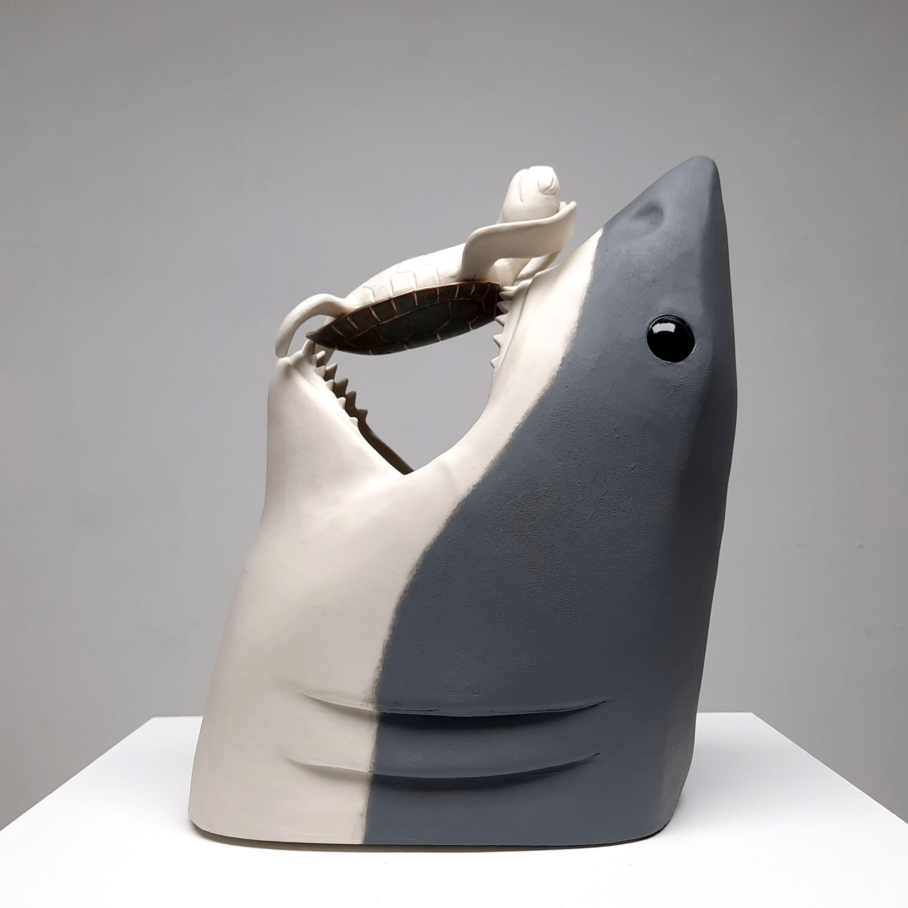 "Life is Short Relax II" by Henk Jan Sanderman is a captivating ceramic tabletop sculpture that invites viewers to embrace the beauty of relaxation and tranquility. This original artwork features two intricately crafted grey shark heads, painted in