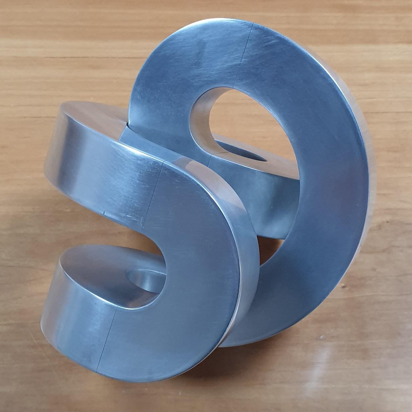 Rondeau (work no. HVP01444) is a small size contemporary modern abstract geometric aluminum sculpture by acclaimed Dutch constructivist Henk van Putten, who was born in The Netherlands but for many years lived and worked in Auroville, India. Upon