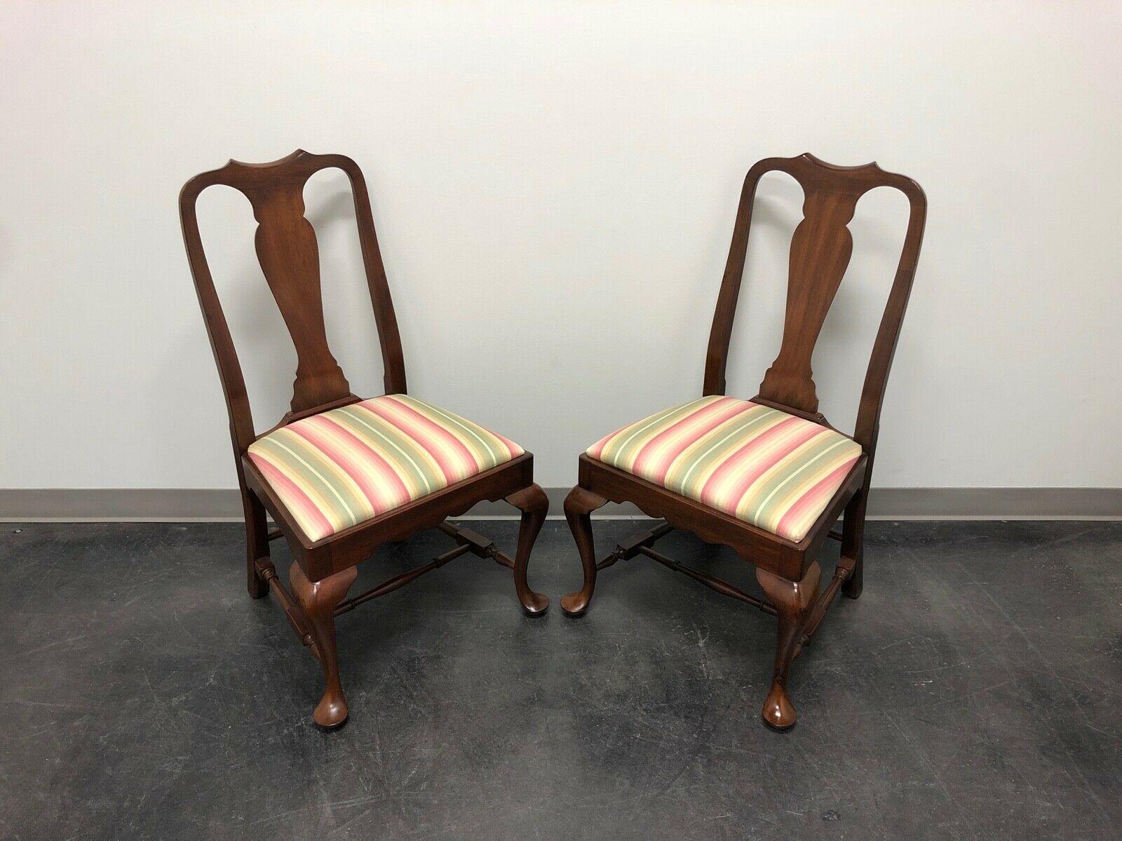 A pair of Queen Anne style dining side chairs by Henkel Harris, an SPNEA (Society for the Preservation of New England Antiquities) approved 18th Century reproduction. Mahogany with carved back, stripe fabric upholstered seat, cabriole legs,