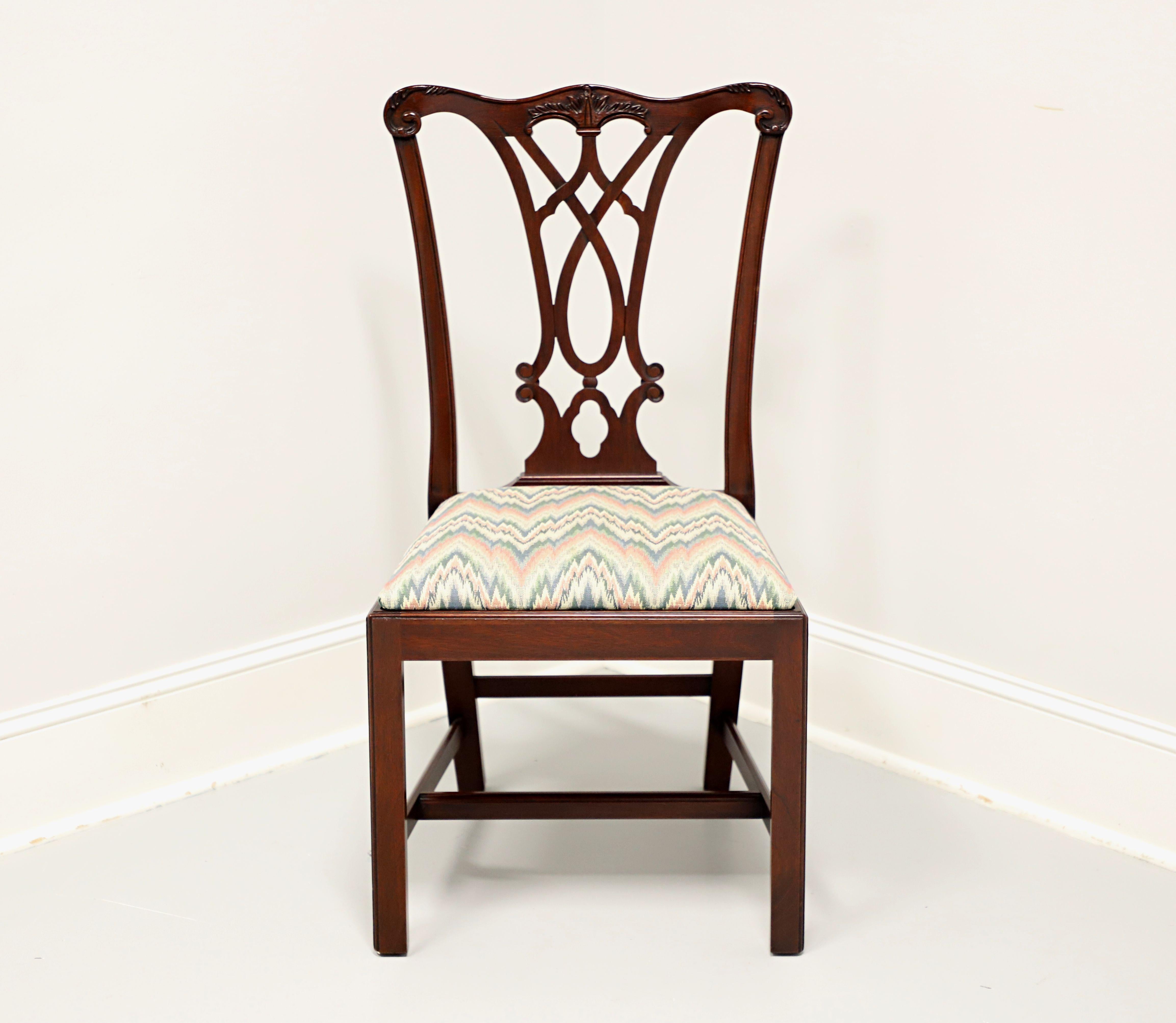 A Chippendale style dining side chair by Henkel Harris, of Winchester, Virginia, USA. Solid mahogany, carved crest rail & backrest, multi-color flame stitch pattern fabric upholstered seat, straight legs and stretchers. Made in 1992. 

Style #:
