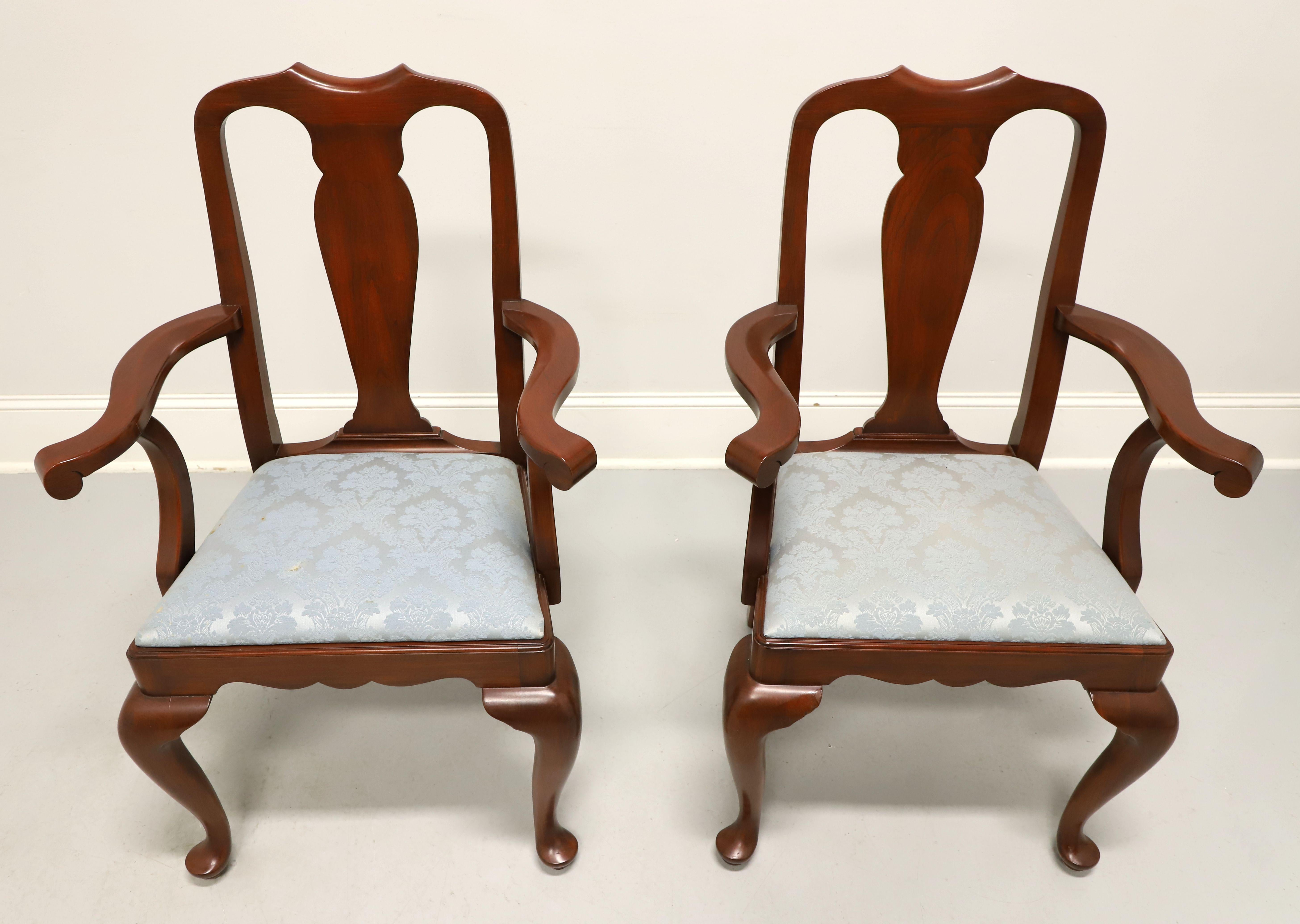 A pair of Queen Anne style dining armchairs by Henkel Harris, of Winchester, Virginia, USA. Solid wild black cherry wood, carved crest rail, carved center backrest, curved arms with arched supports, upholstered seat in a light blue brocade fabric,