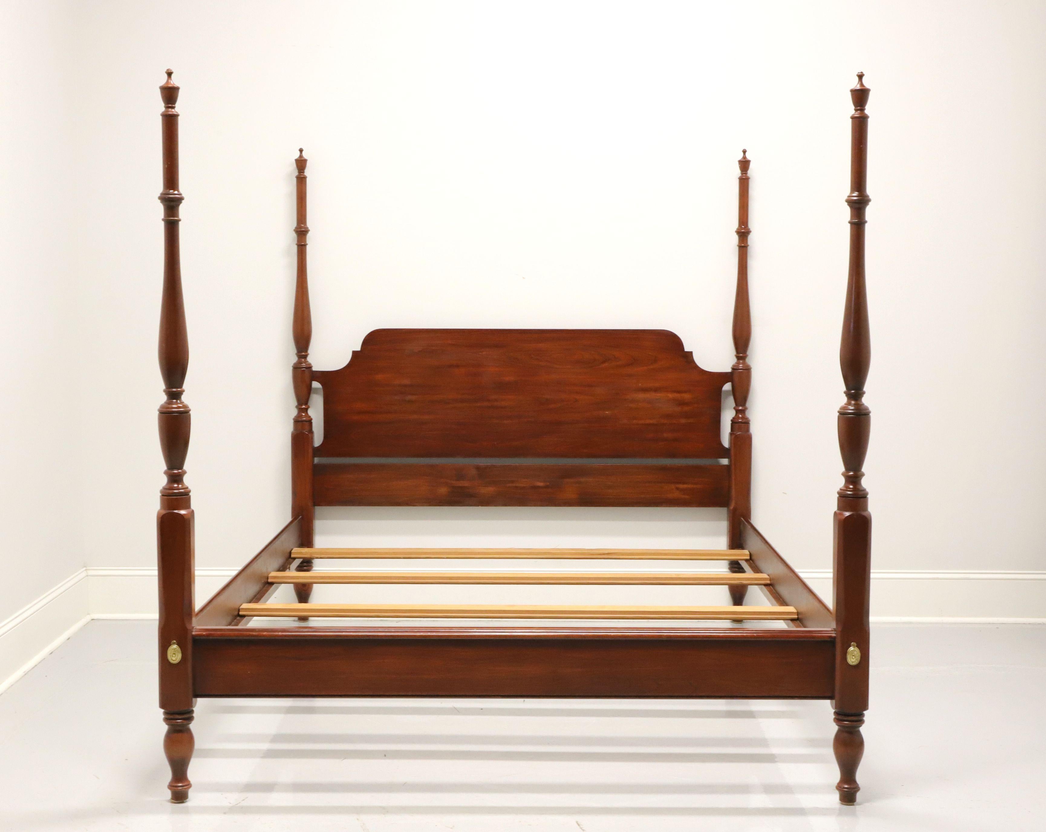 A traditional style queen size poster bed by Henkel Harris of Winchester, Virginia, USA. Solid wild black cherry, four turned posts with finials, brass accents to footboard and turned feet. Wood slat mattress supports rest on side rails. Made circa