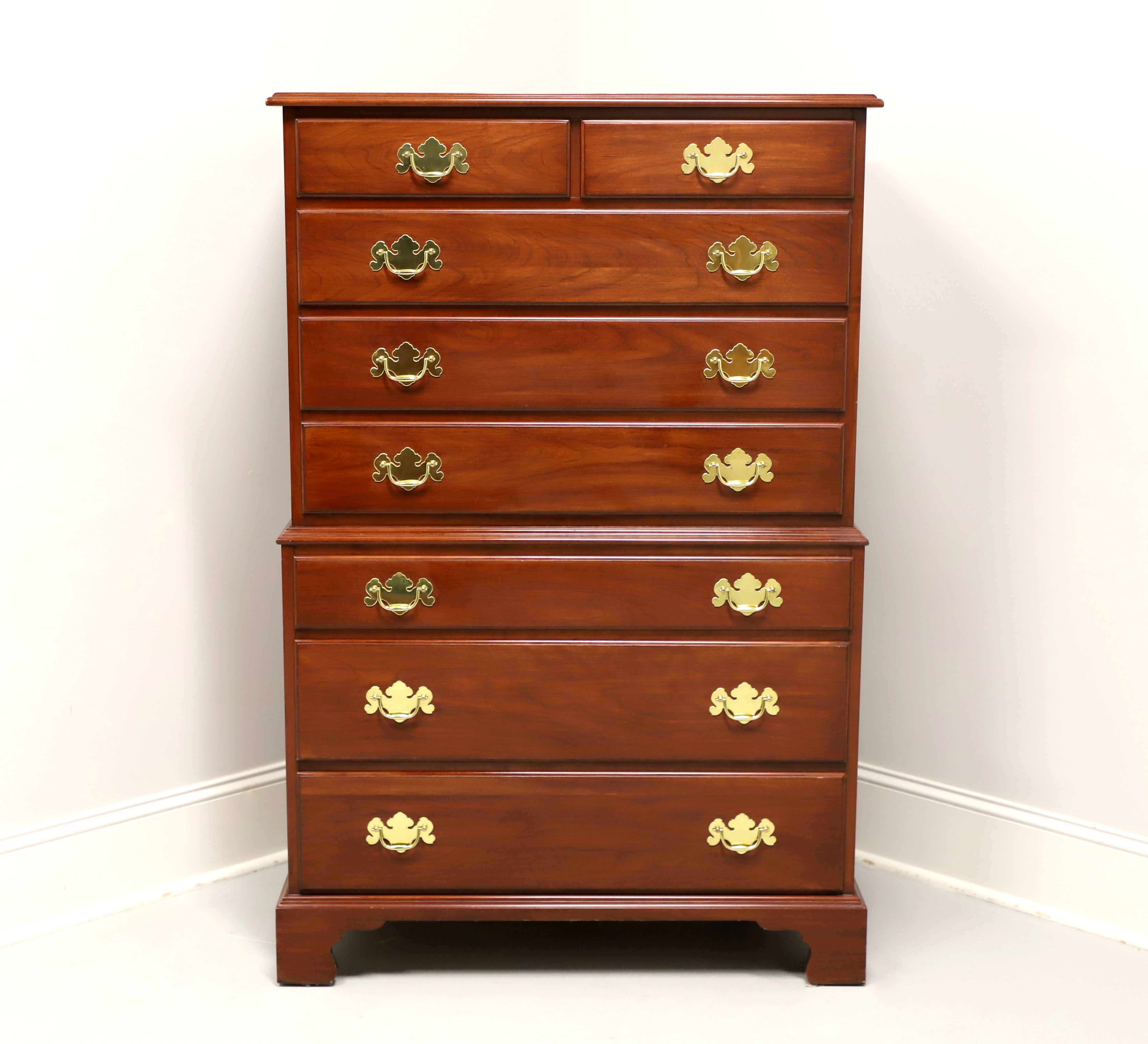 A Chippendale style chest on chest by Henkel Harris of Winchester, Virginia, USA, their Rafferty Chest. Solid wild black cherry wood with brass hardware, ogee edge to top, ogee edge at middle to separate chests, and bracket feet. Features eight