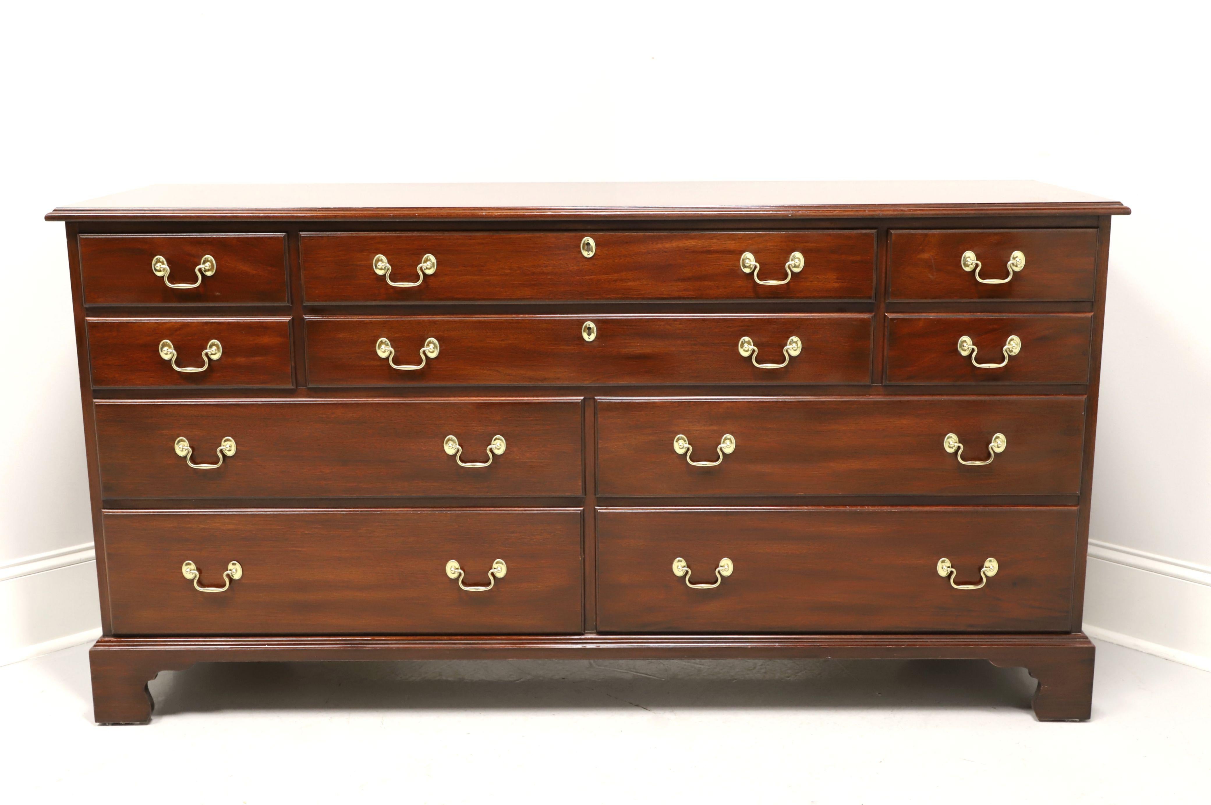 A triple dresser in the Chippendale style by Henkel Harris, of Winchester, Virginia, USA. Solid mahogany with brass hardware and bracket feet. Features ten various size drawers of dovetail construction, two center with faux keyhole escutcheons and