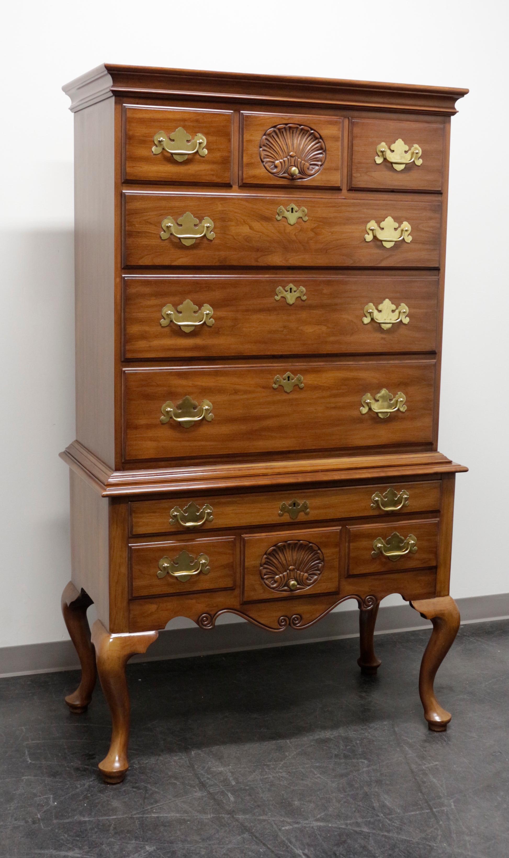 A Queen Anne style highboy chest of drawers by Henkel Harris of Winchester, Virginia, USA. Made in 1968. Solid wild black cherry with brass hardware. Features ten dovetailed drawers, four lockable with key, crown molding at top, cabriole legs and