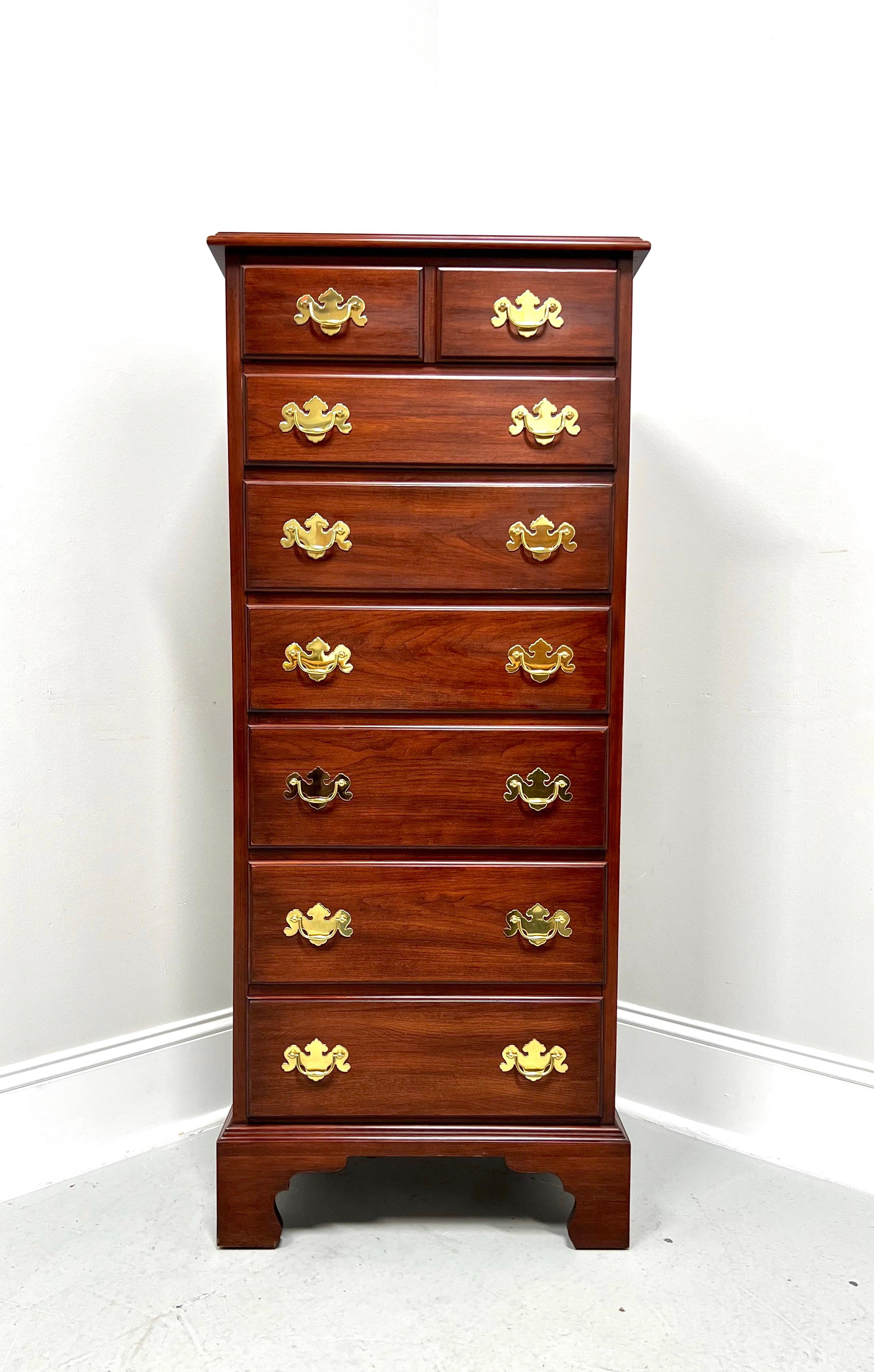 A semainier lingerie chest in the Chippendale style by Henkel Harris, of Winchester, Virginia, USA. Solid wild black cherry wood with brass hardware, bevel edge to top, and bracket feet. Features seven drawers of dovetail construction, with top