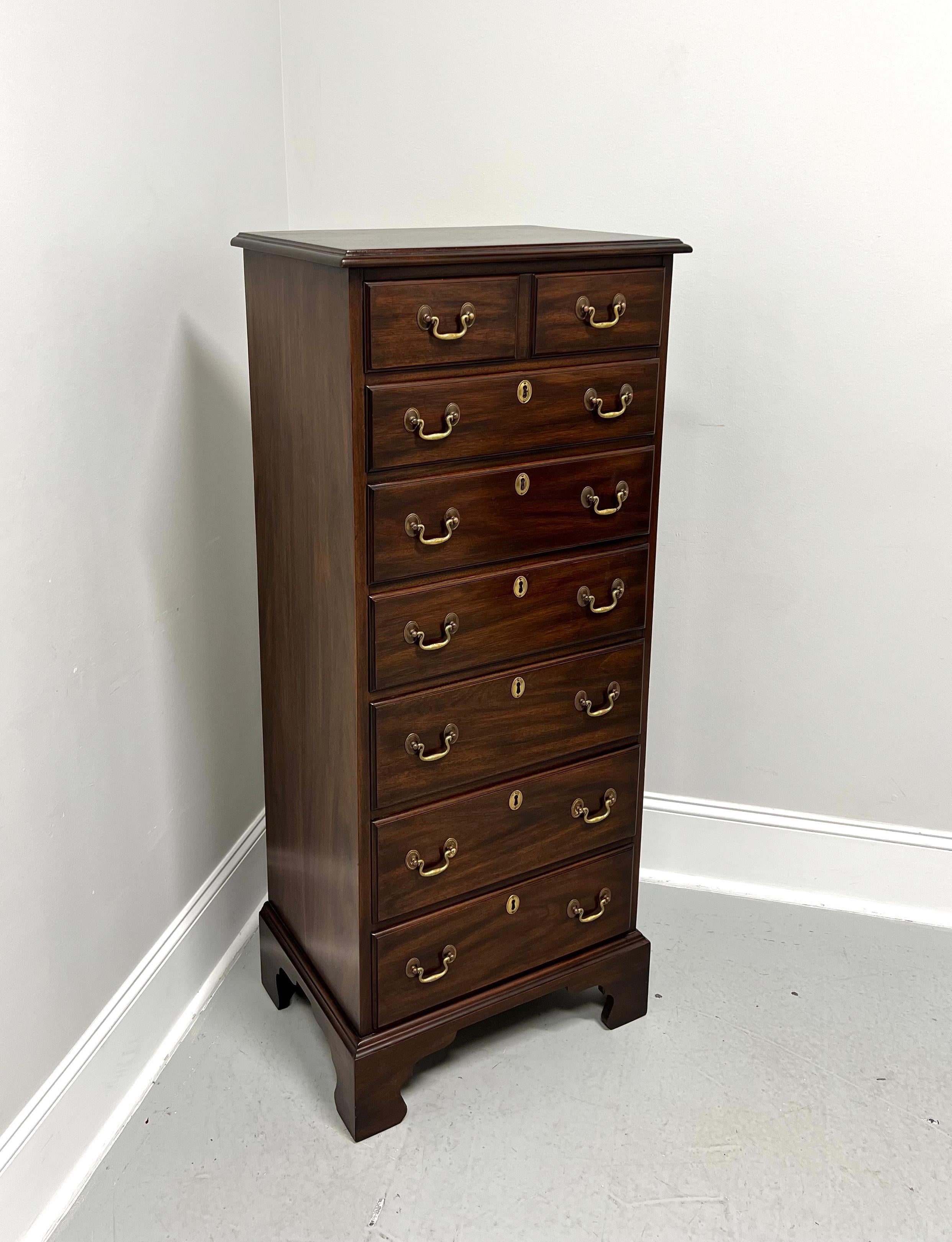 A semainier lingerie chest in the Chippendale style by Henkel Harris, of Winchester, Virginia, USA. Solid mahogany with brass hardware, ogee edge to top, and bracket feet. Features seven drawers of dovetail construction, with top drawer having a