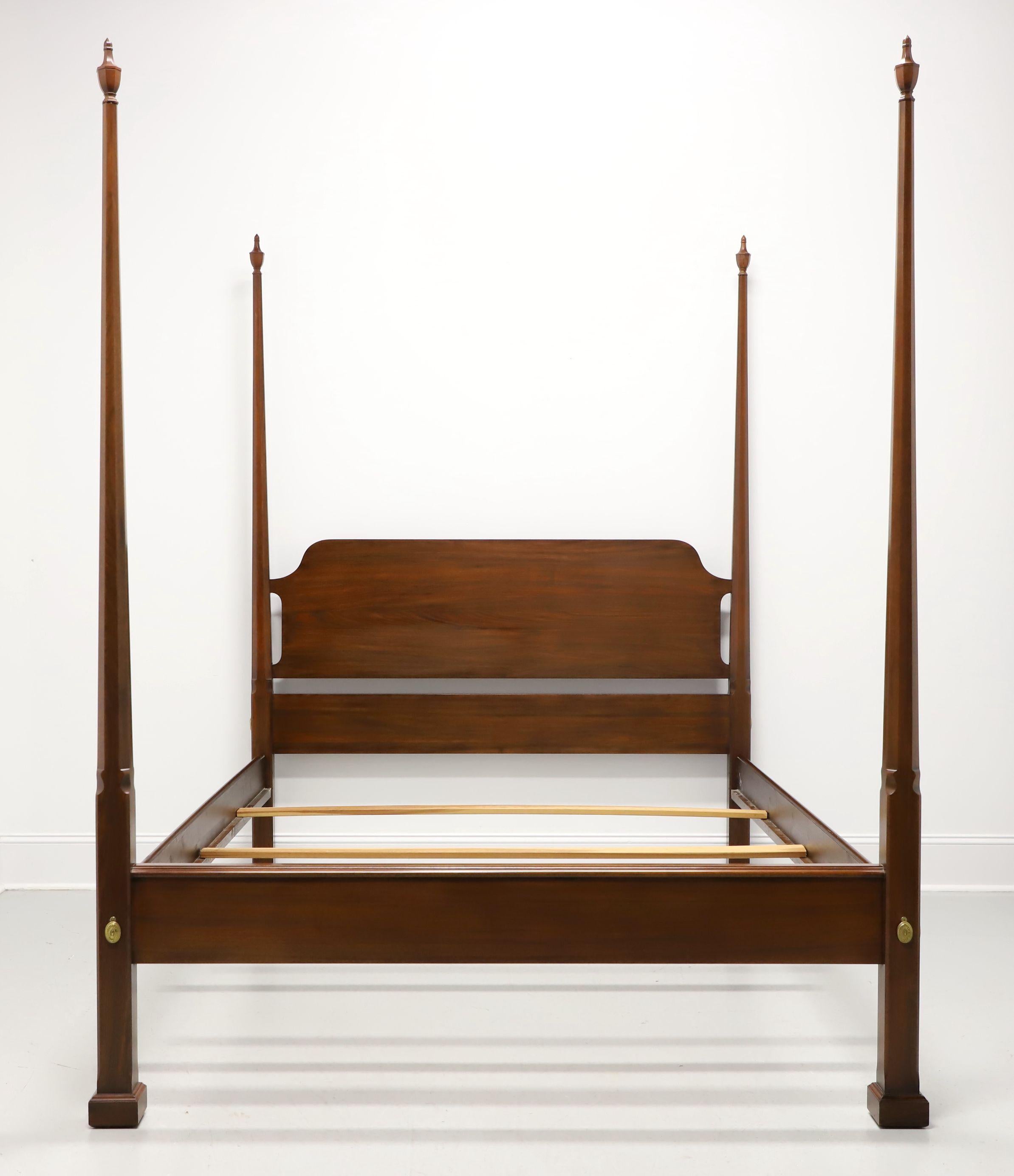 A Traditional style queen size pencil post bed by Henkel Harris, of Winchester, Virginia, USA. Genuine black walnut wood with four pencil shaped posts with finials, brass covers to headboard & footboard, metal clip held side rails with wood bracers,
