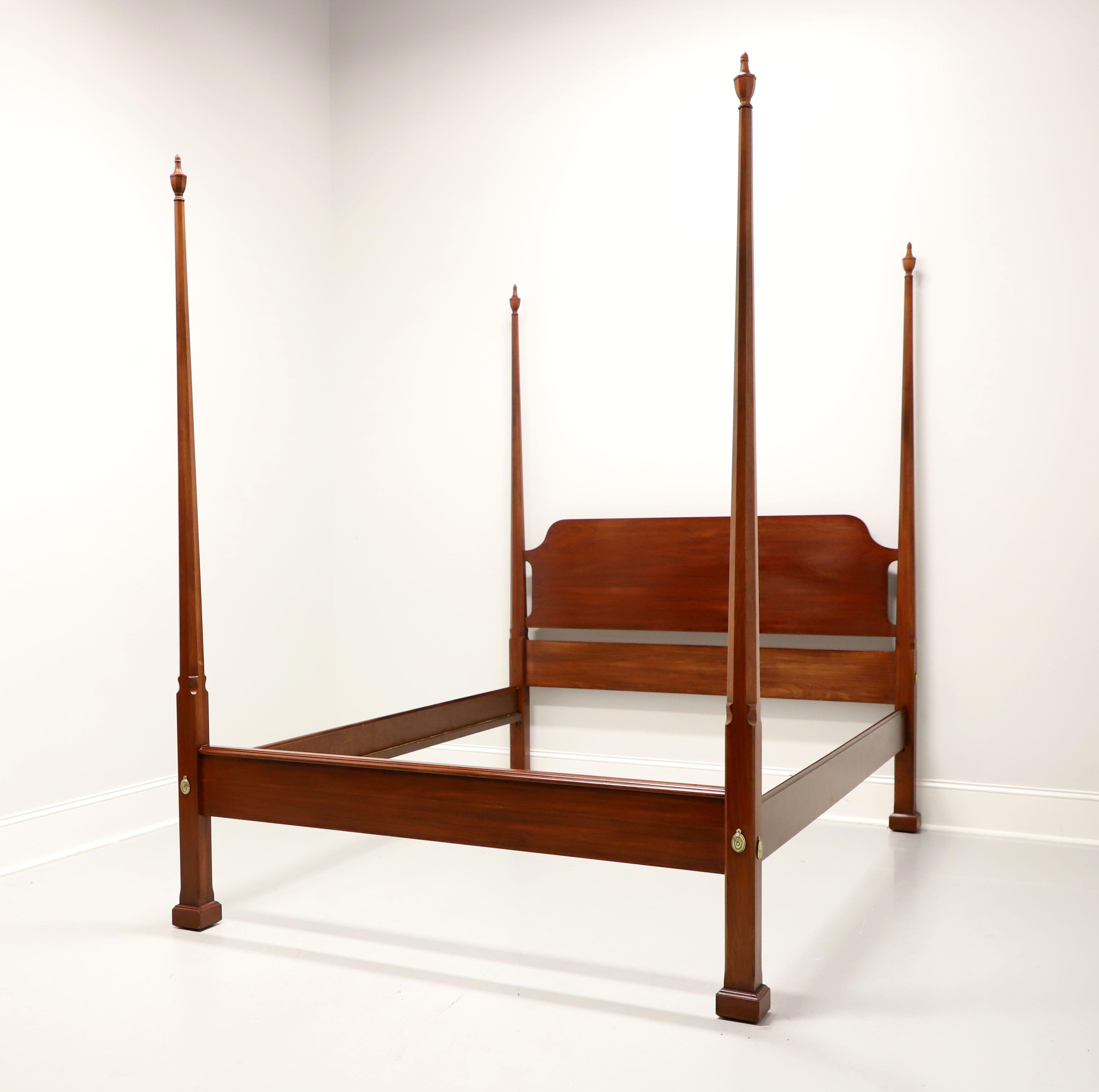 A Traditional style queen size pencil post bed by Henkel Harris, of Winchester, Virginia, USA. Solid wild black cherry wood with four pencil shaped posts with finials, brass covers to headboard & footboard, metal clip held side rails with wood