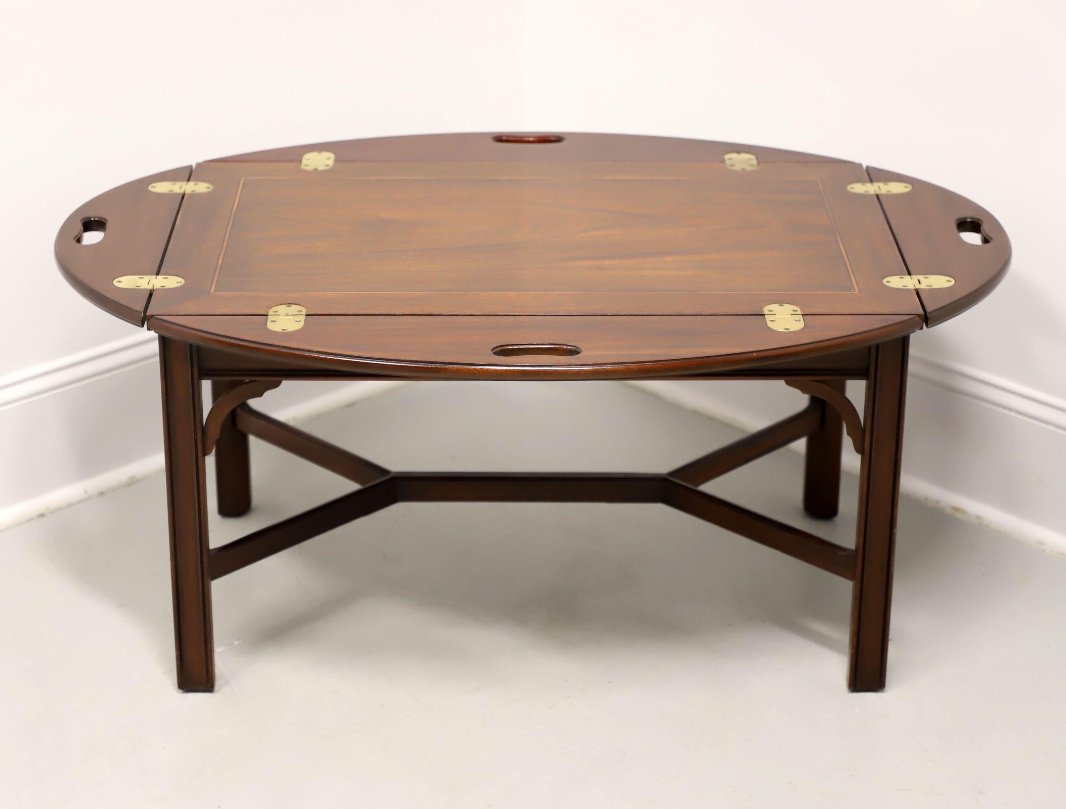 A Chippendale style butler's tray coffee table by Henkel Harris, of Winchester, Virginia, USA. Solid mahogany with brass hinge hardware, banded top, 