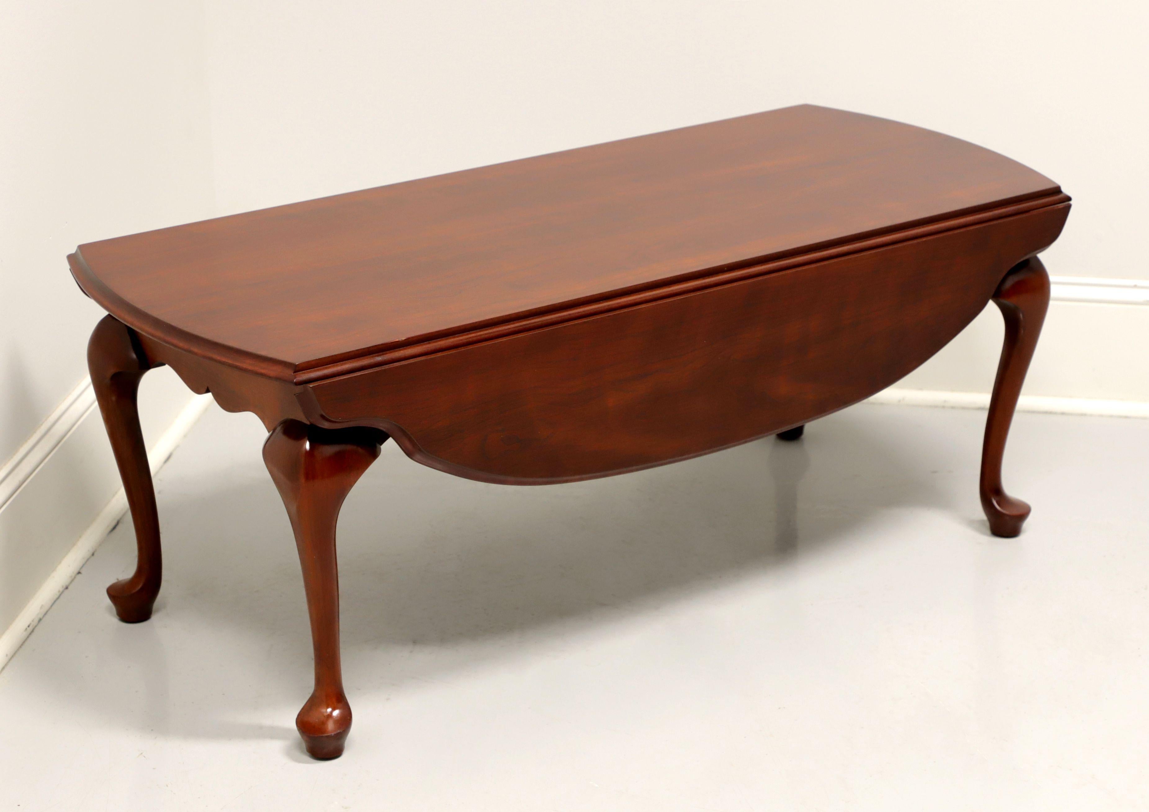 A Queen Anne style drop-leaf coffee table by Henkel Harris, of Winchester, Virginia, USA. Solid cherry, scalloped edge to drop leaves, carved apron, cabriole legs, pad feet. Made circa 1995.

Style #: 5234, Finish #: 24

Measures: 45 W 19.75 D