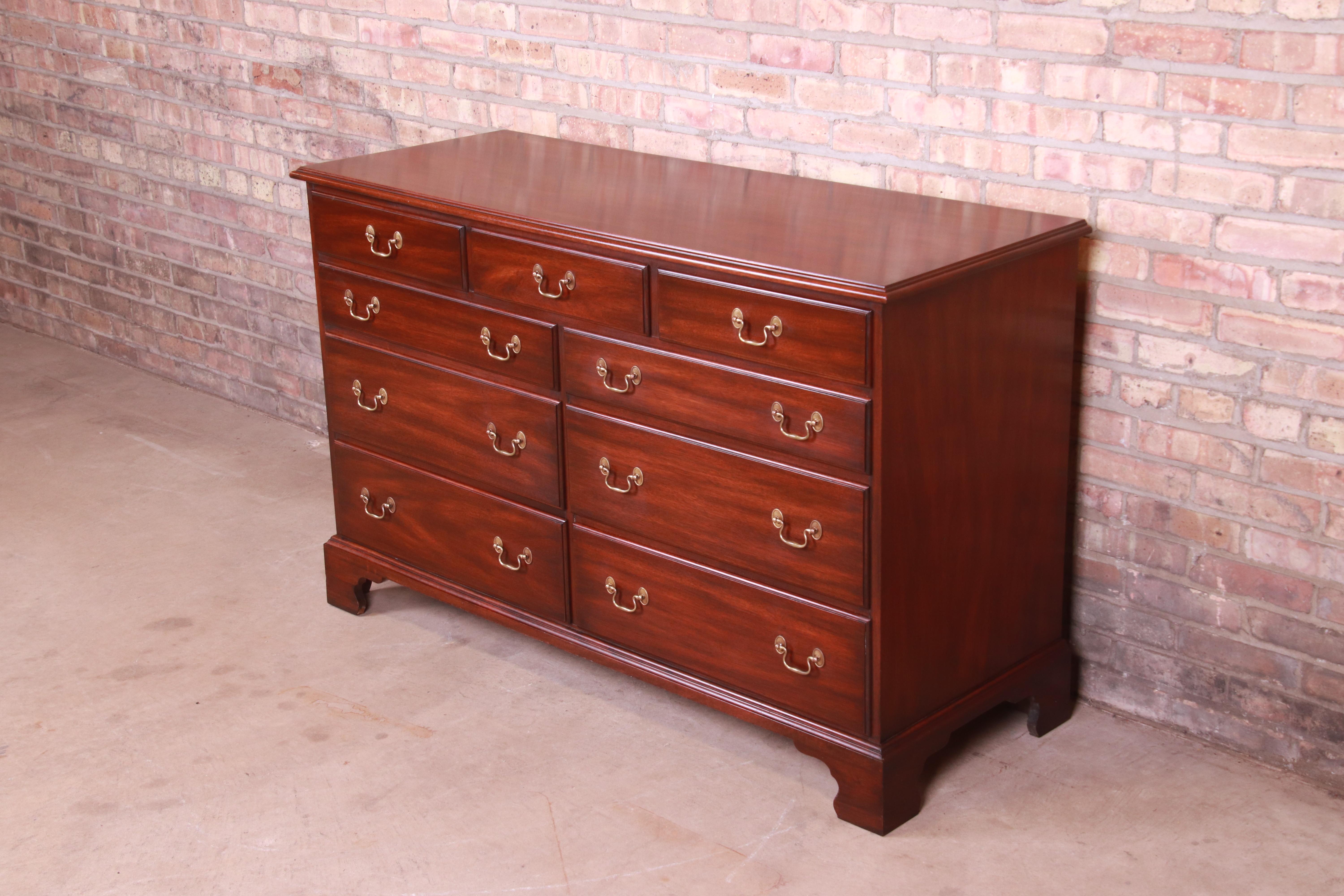 An exceptional American Chippendale style nine-drawer dresser or credenza

By Henkel Harris

USA, 1970s

Carved solid mahogany, with original brass hardware.

Measures: 54.25