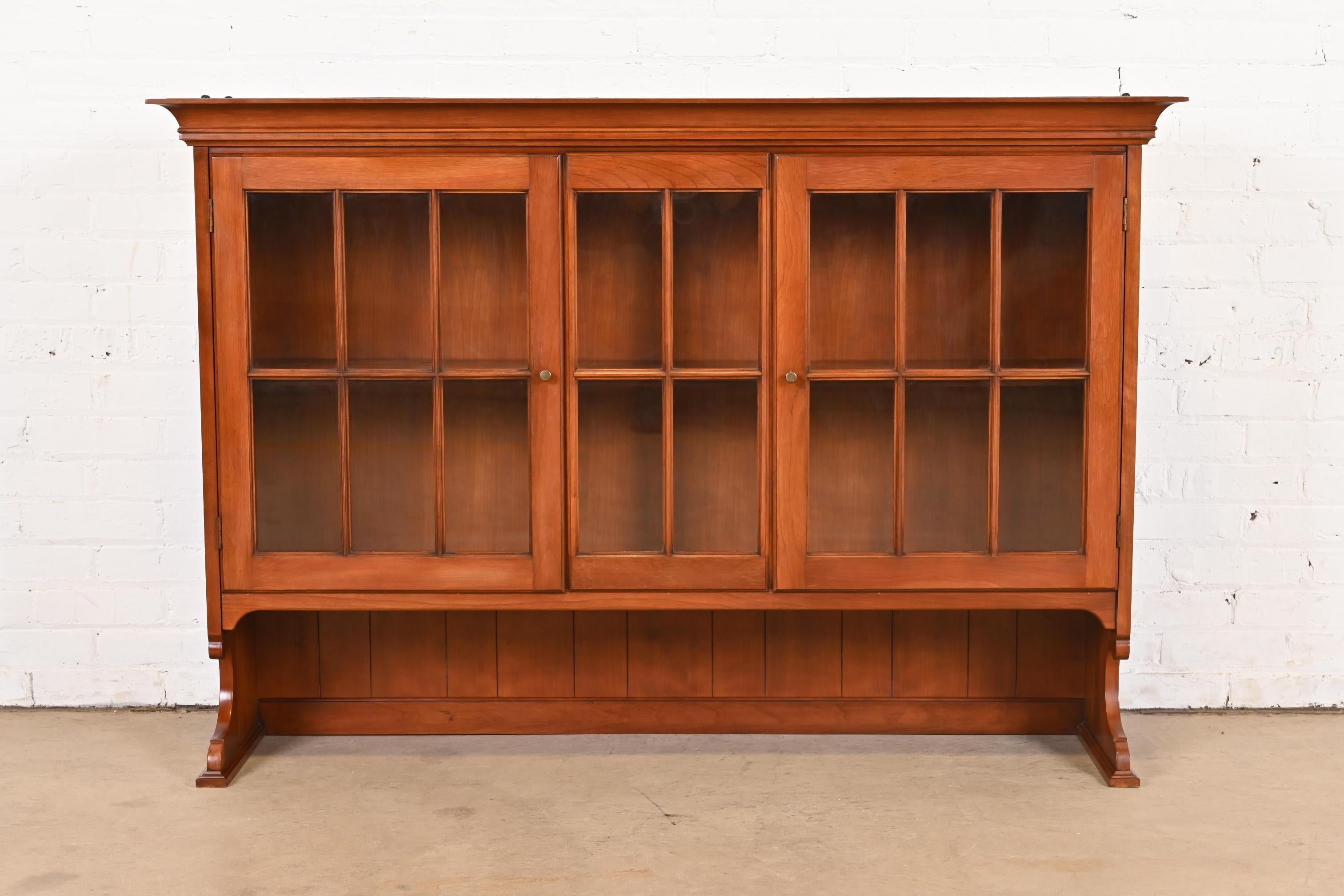A gorgeous American Colonial or Chippendale style bookcase hutch

By Henkel Harris

USA, Circa 1970s

Solid wild black cherry wood, with mullioned glass front doors and original brass hardware.

Measures: 55.75