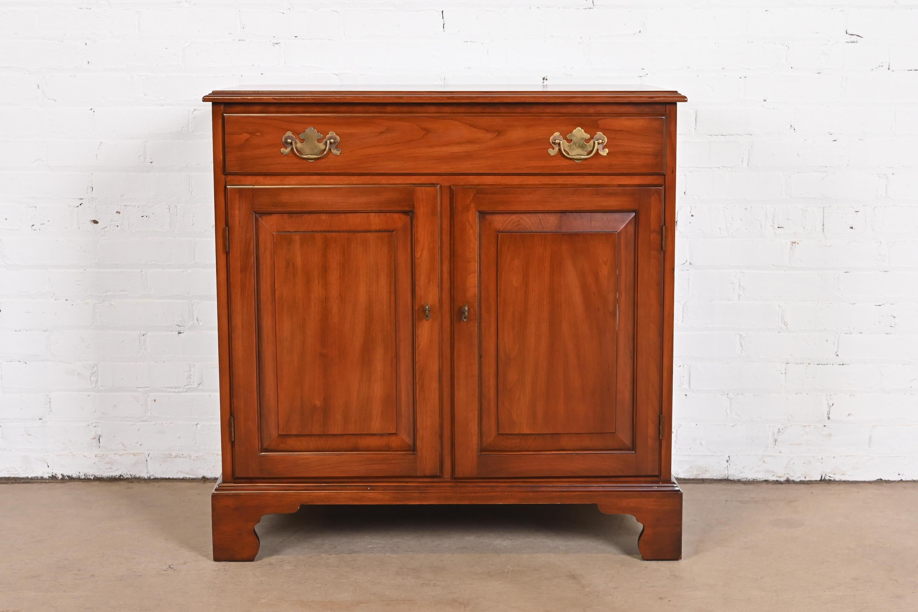 A gorgeous American Colonial or Chippendale style buffet server or bar cabinet

By Henkel Harris

USA, circa 1960s

Solid wild black cherry wood, with original brass hardware.

Measures: 34.25