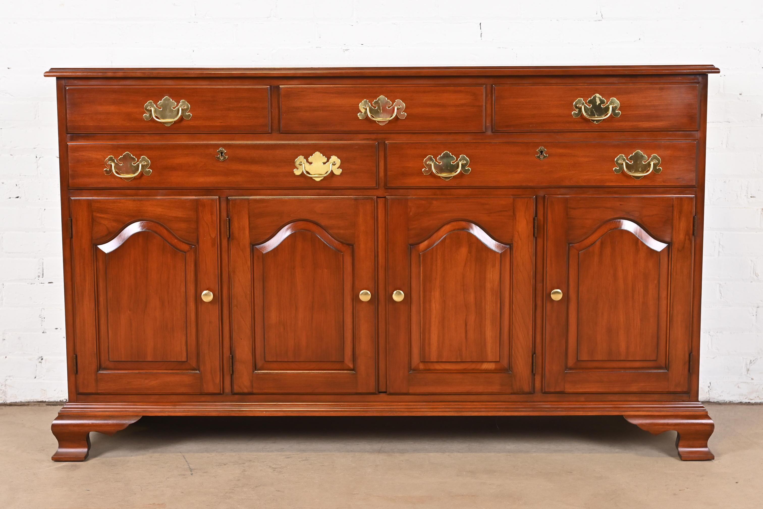 A gorgeous American Colonial or Chippendale style sideboard, buffet server, or bar cabinet

By Henkel Harris

USA, 1980s

Solid wild black cherry wood, with original brass hardware. Two drawers lock, and key is included. Lower cabinet with interior