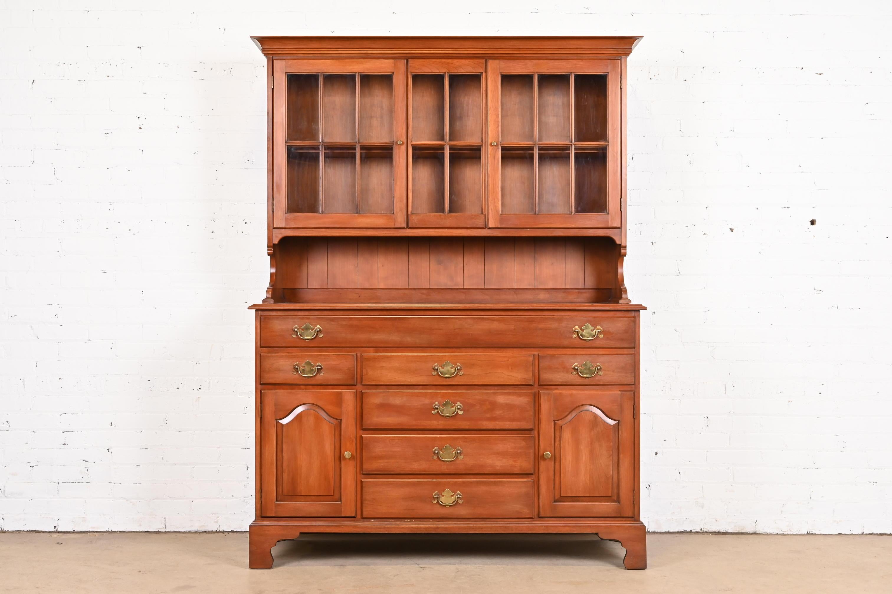 A gorgeous American Colonial or Chippendale style sideboard or buffet server with hutch top

By Henkel Harris

USA, Circa 1970s

Solid wild black cherry wood, with original brass hardware, and glass doors.

Measures: 55.75