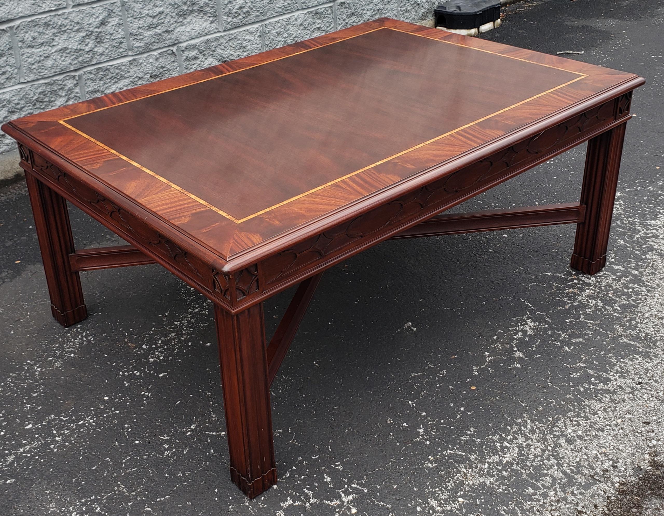 Henkel Harris Banded Flame Mahogany Satinwood Inlay Coffee Table with Fretwork.
Figured mahogany veneer top with crotch mahogany border with tulipwood
inlay and anigre separators. Apron has blind fret with Gothic motif and framed
diamond above legs.
