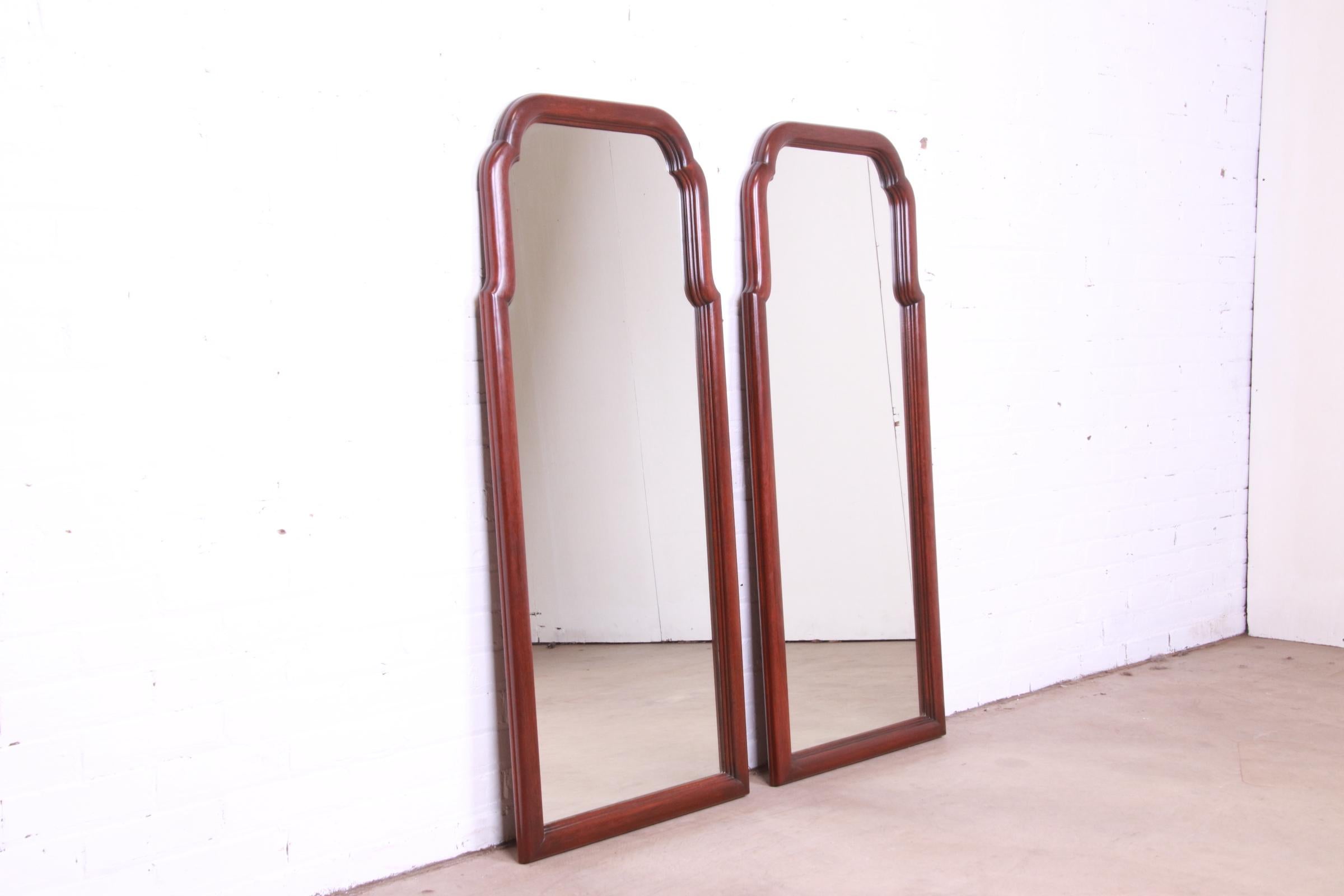 A beautiful pair of tall traditional carved mahogany framed wall mirrors

By Henkel Harris

USA, Circa 1970s

Measures: 21.5