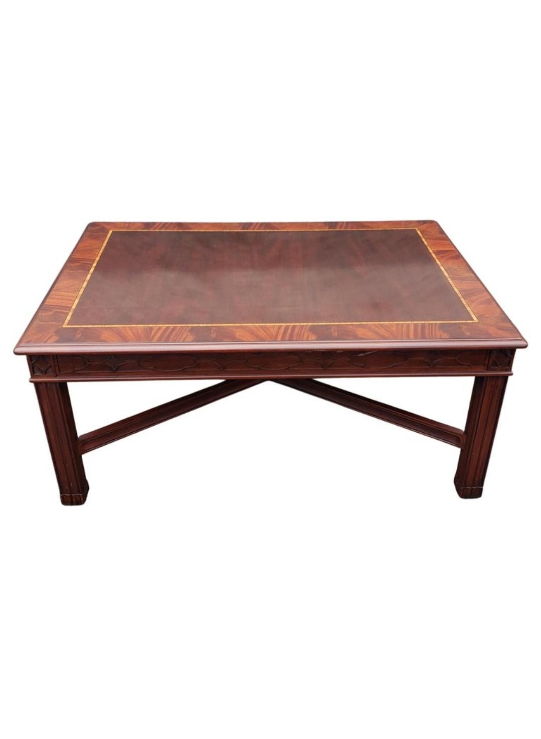 A Recently refinished Henkel Harris Banded Flame Mahogany , tulipwood and Satinwood Inlay Coffee Table with blind Fretwork.
Figured mahogany veneer top with crotch mahogany border with tulipwood
inlay and anigre separators. Apron has blind fret with