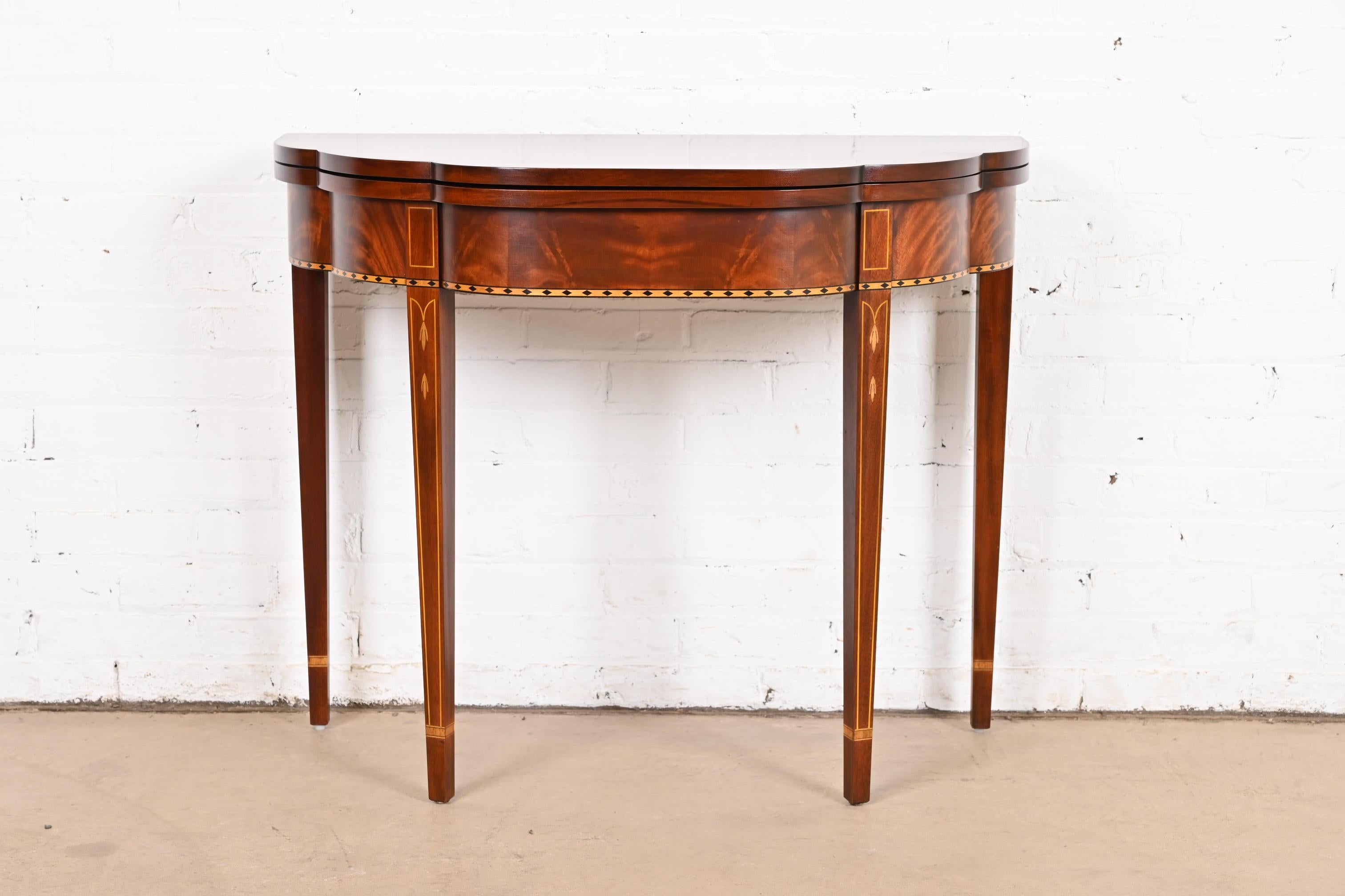 A gorgeous Federal or Hepplewhite style flip top demilune console game table

By Henkel Harris 

USA, Circa Late 20th Century

Beautiful flame mahogany, with satinwood inlay.

Measures: 36