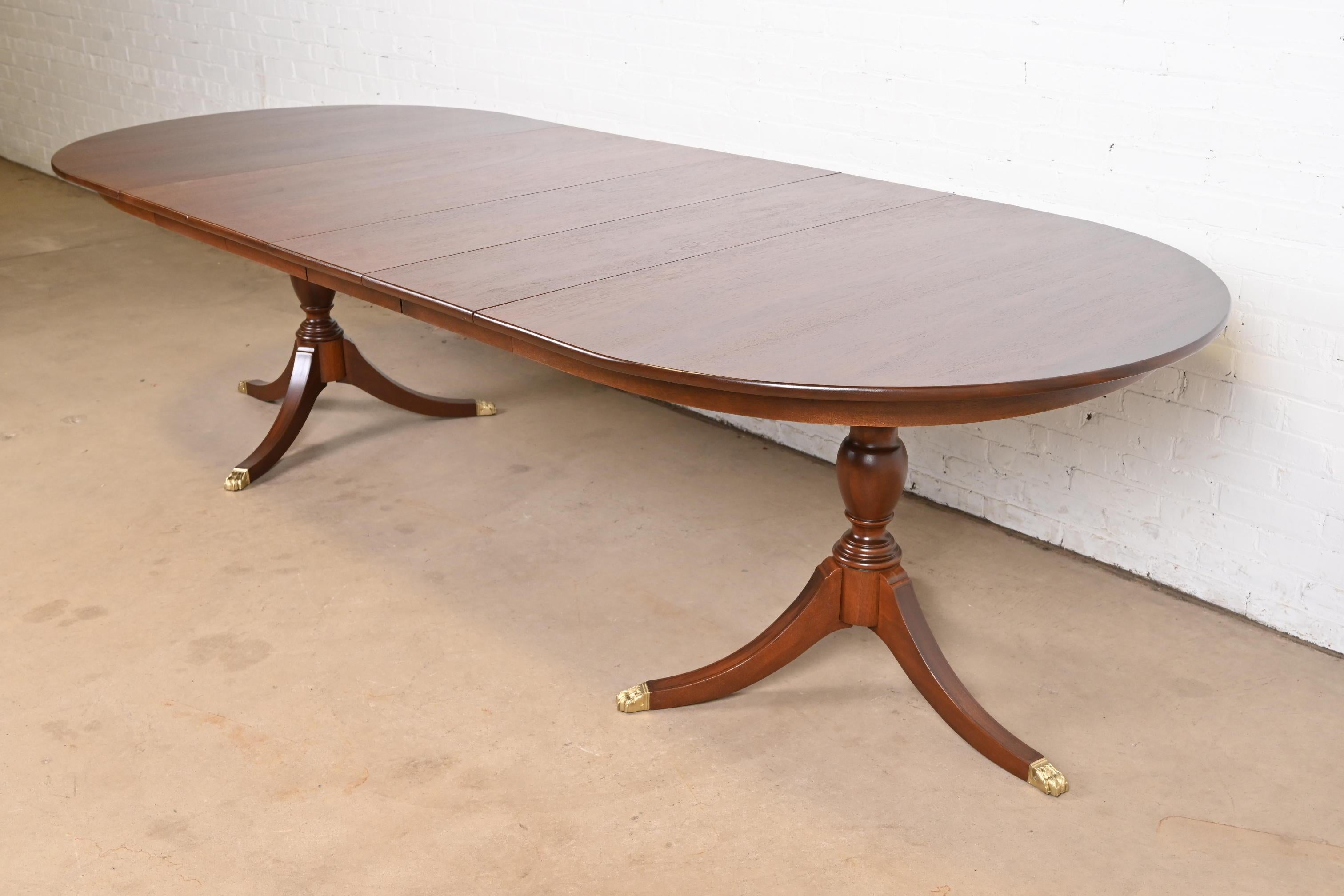 An exceptional Georgian or Regency style double pedestal extension dining table

By Henkel Harris

USA, 1970

Gorgeous solid mahogany, with carved pedestals and brass-capped paw feet.

Measures: 65.25