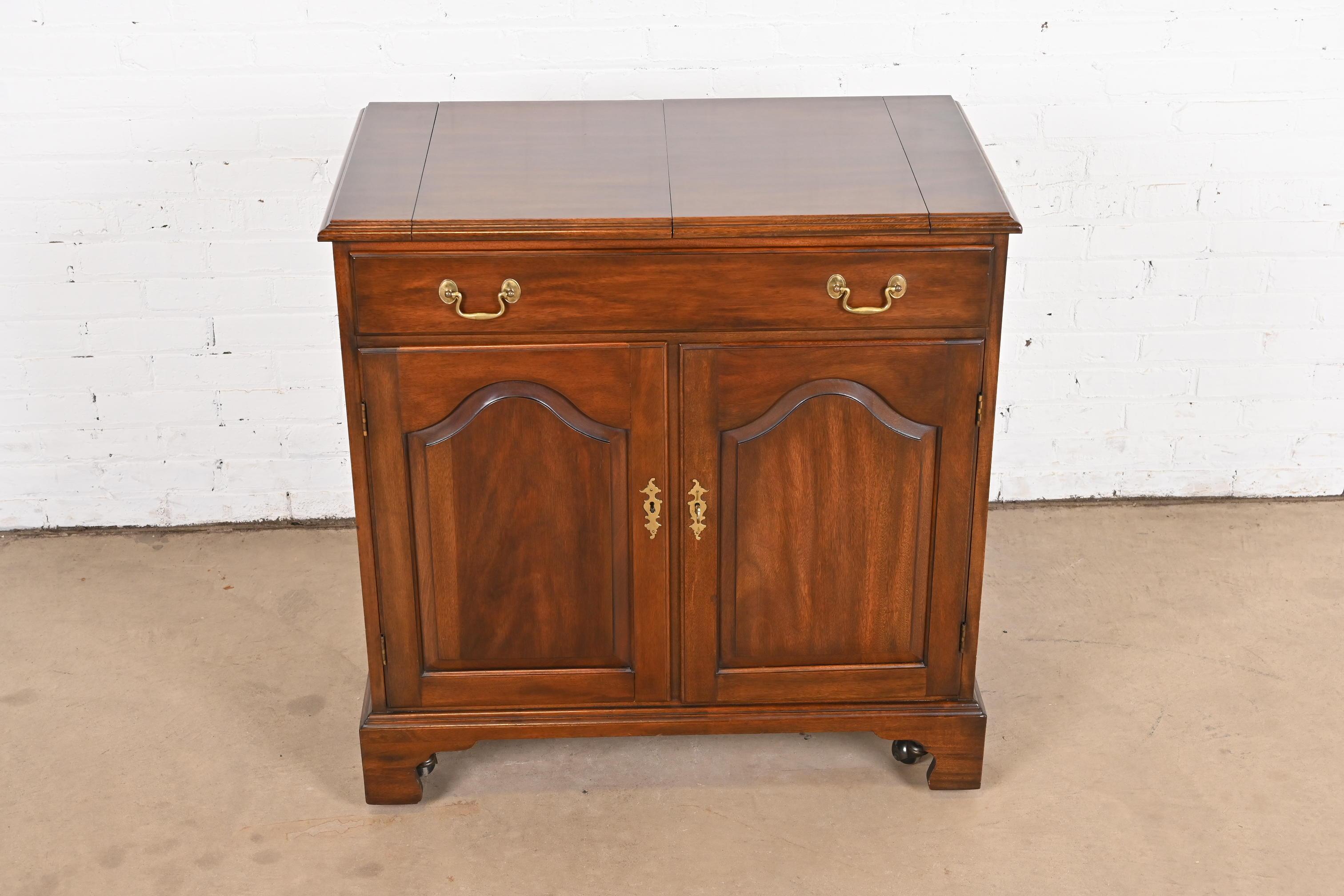 A gorgeous Georgian or Chippendale style flip-top rolling buffet server or bar cabinet

By Henkel Harris

USA, 1974

Solid mahogany, with original brass hardware. Cabinet locks, and key is included.

Measures: 34.25
