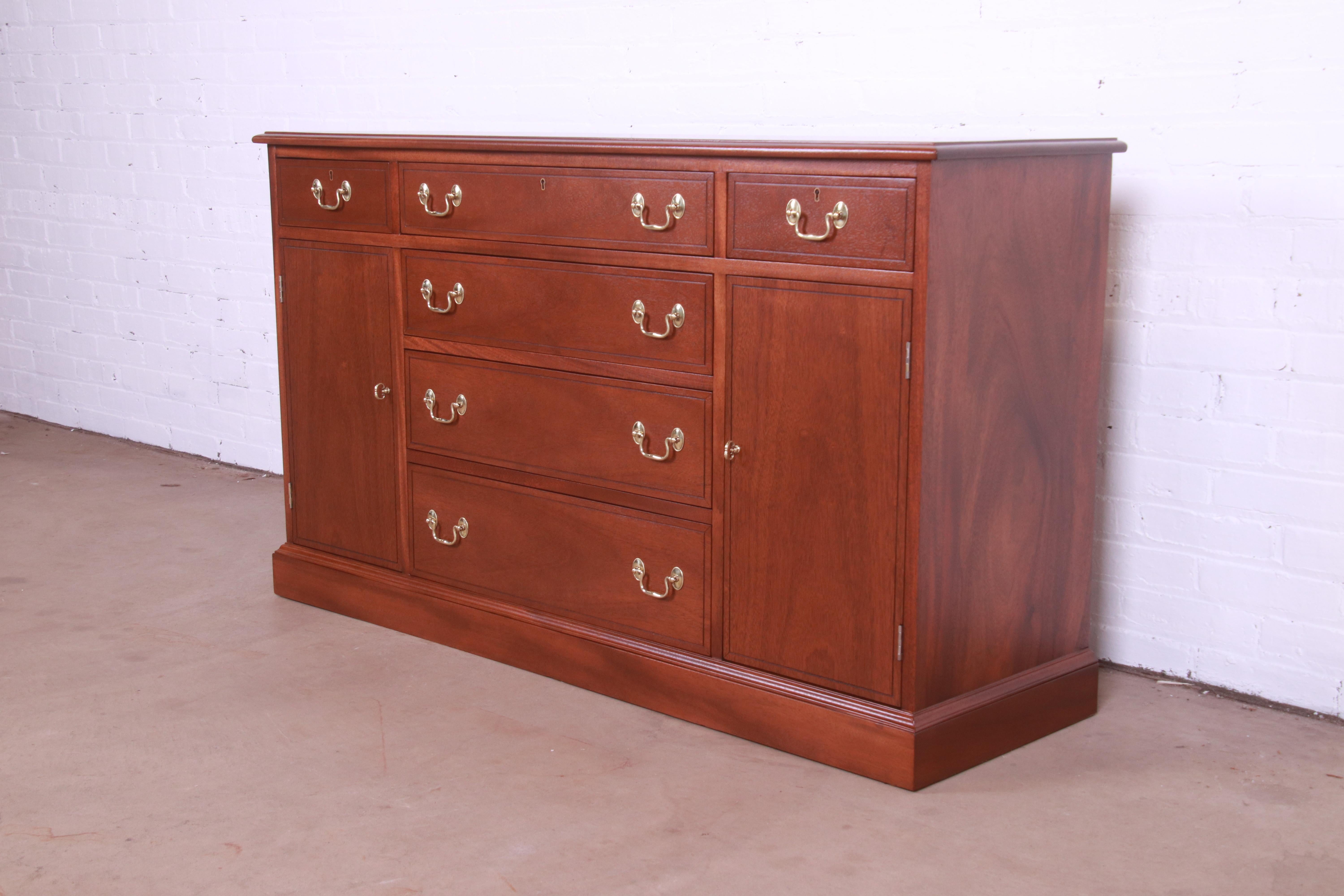 A gorgeous Georgian style sideboard, credenza, or bar cabinet.

By Henkel Harris

USA, 1971

Solid mahogany, with original brass hardware. Top drawers lock, and key is included.

Measures: 54.75