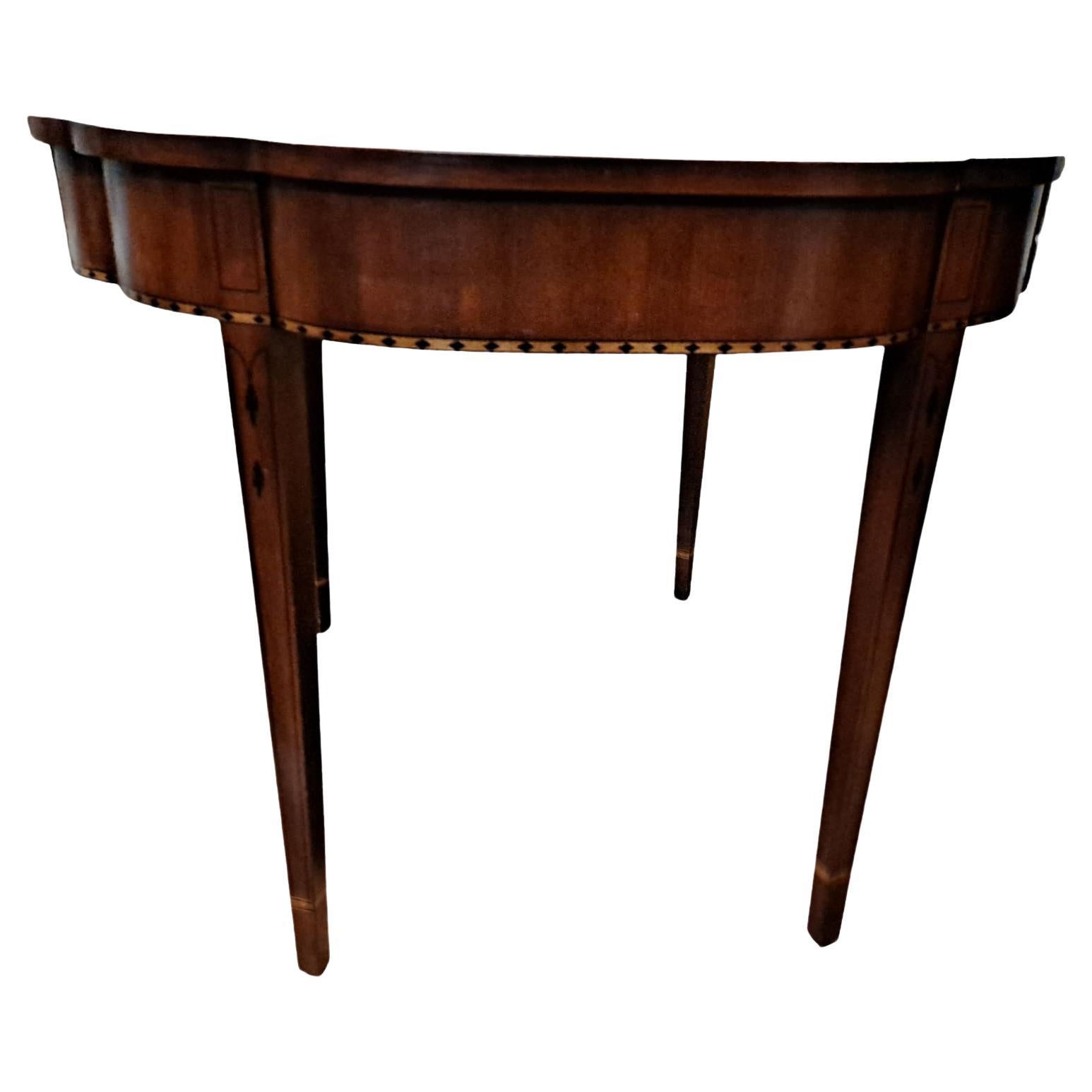 Henkel-Harris Mahogany Flip-Top Games Table

Mid-20th century 

Beautiful bellflower inlay, elliptical scalloped shaped edge and tapered legs

36W
