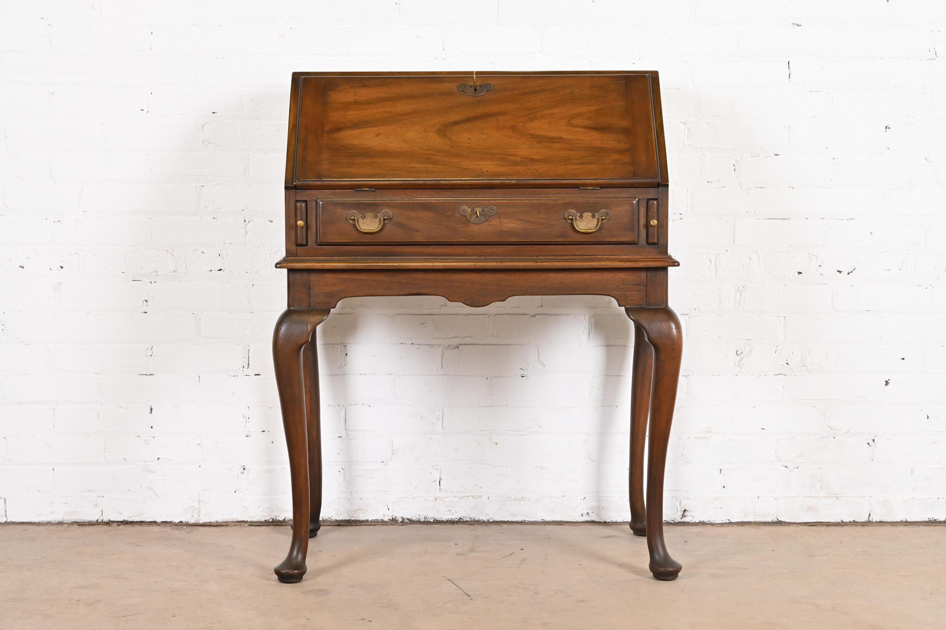 A gorgeous Queen Anne or Georgian style Lady Astor slant front writing desk

By Henkel Harris

USA, Circa 1970s

Solid mahogany, with original brass hardware. Desk locks, and key is included.

Measures: 31